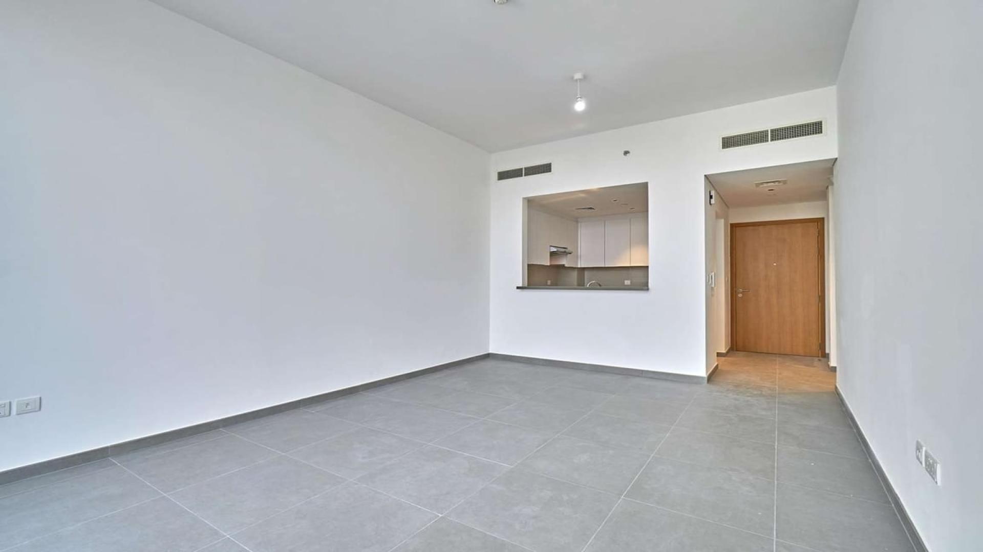 "Modern apartment complex with pool in Mudon Views, ideal for spacious living and relaxation.",Spacious living room in 2-bedroom apartment, Mudon Views, featuring modern open kitchen layout