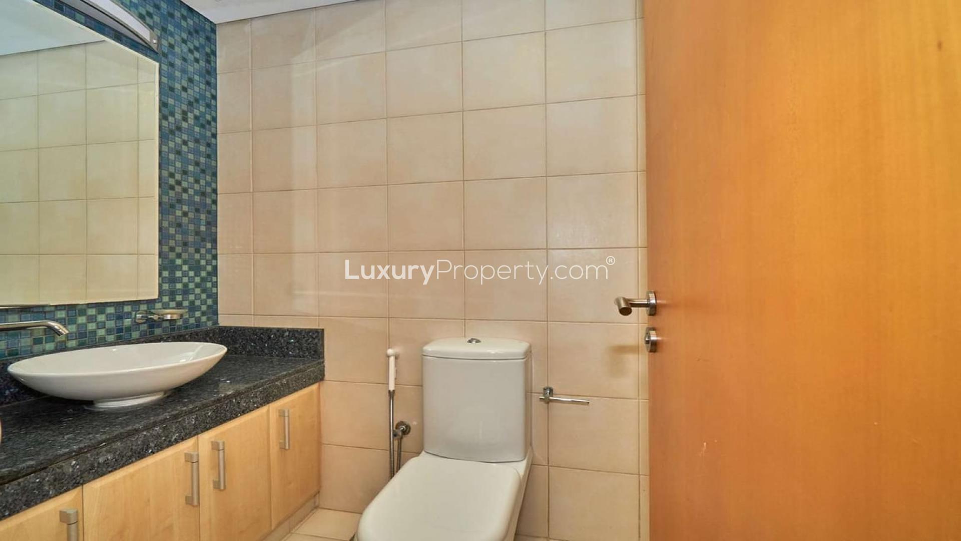 Unfurnished living room in 2-bedroom Palm Jumeirah apartment with large windows and balcony access