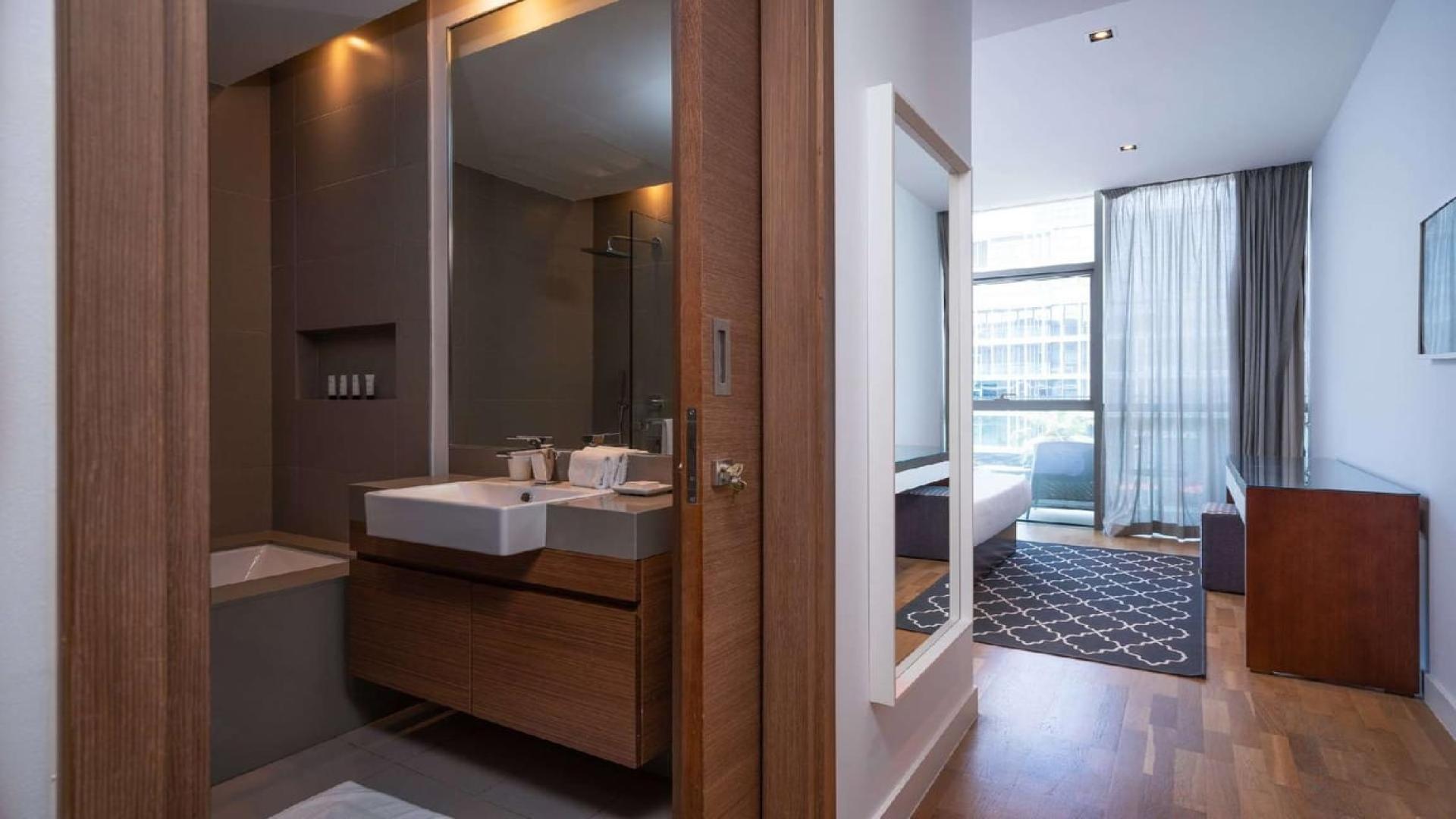 Balcony view from City Walk apartment overlooking modern Dubai skyline and bustling streets