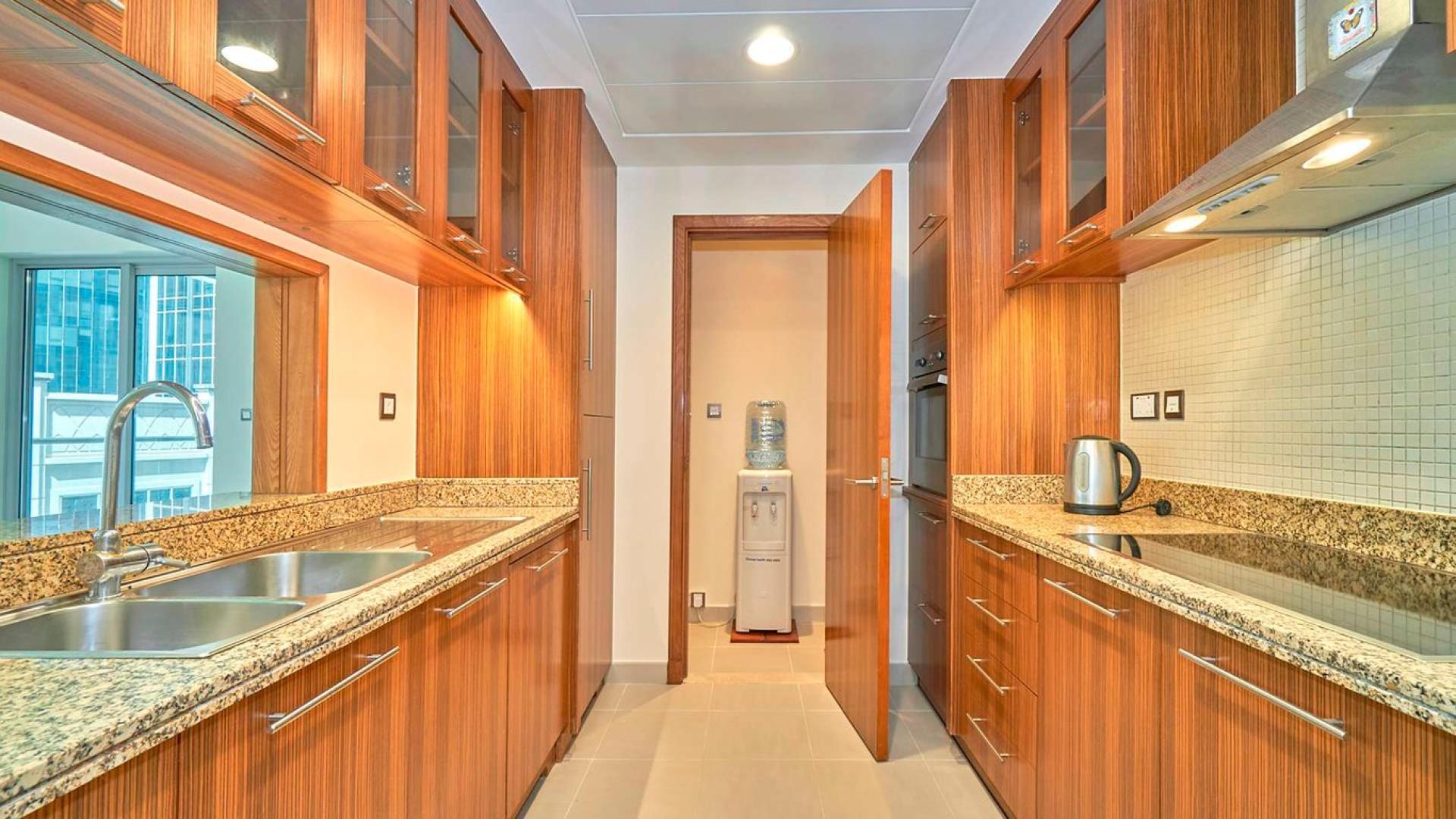 Spacious living room with large windows in Marina Promenade apartment, Dubai Marina