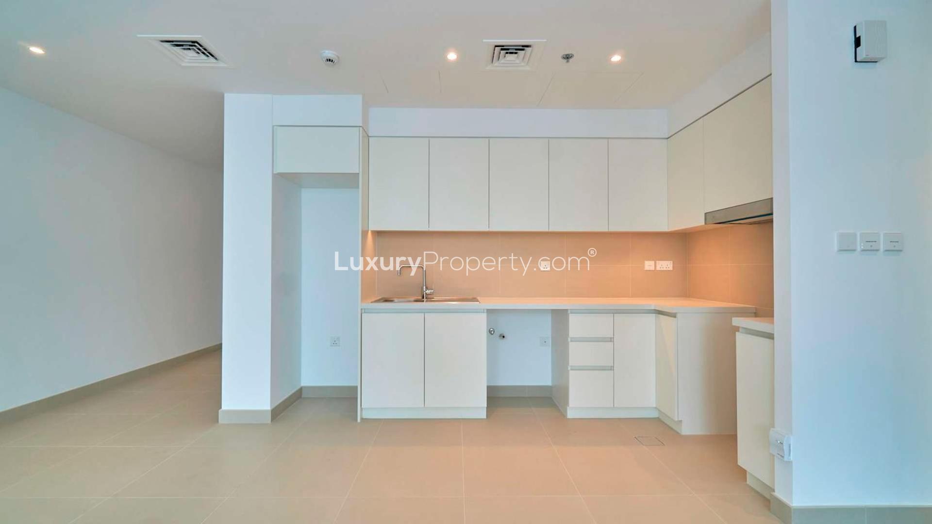 Empty living room with large windows in Dubai Creek Harbour apartment for rent