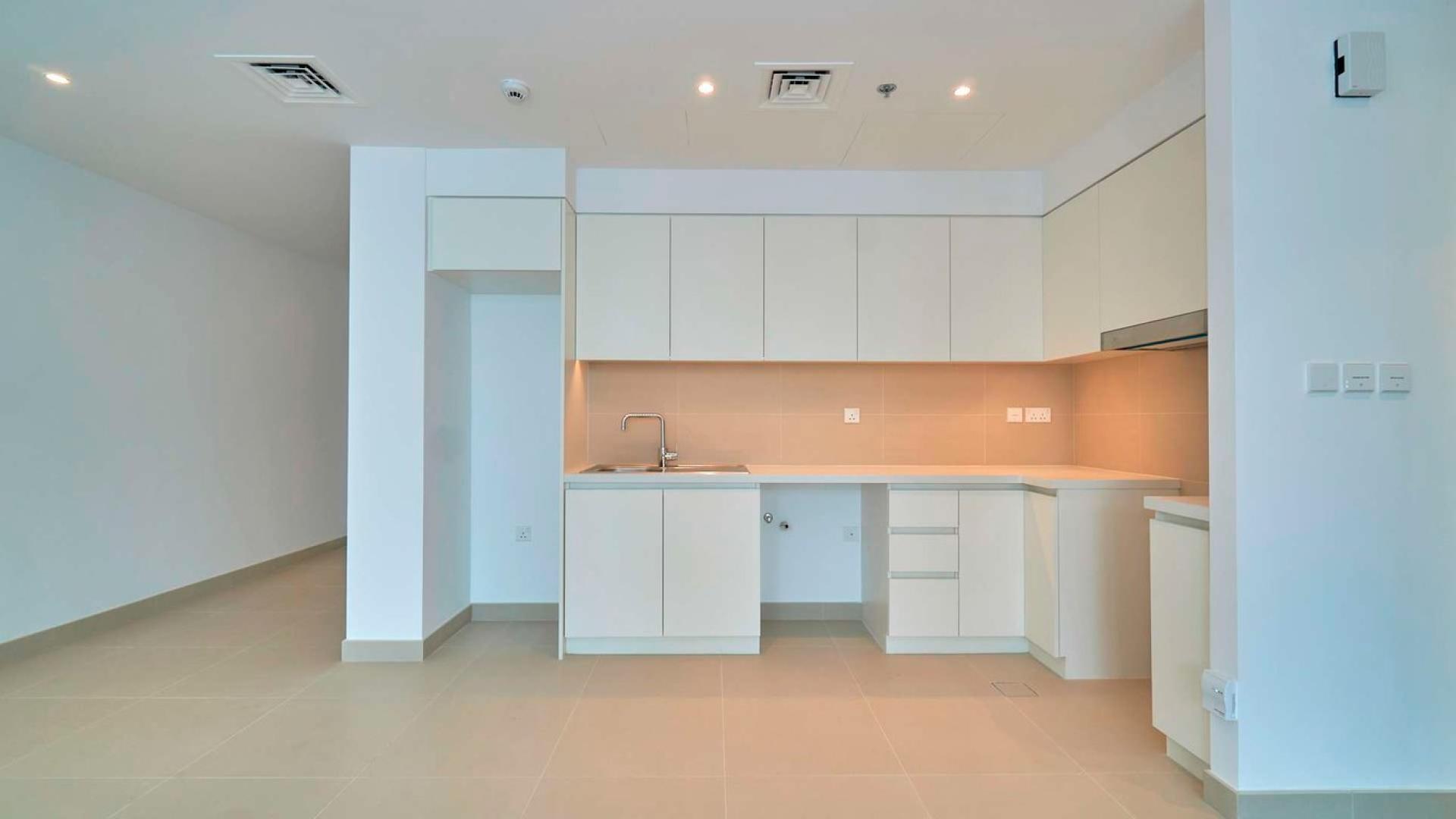 Empty living room with large windows in Dubai Creek Harbour apartment for rent