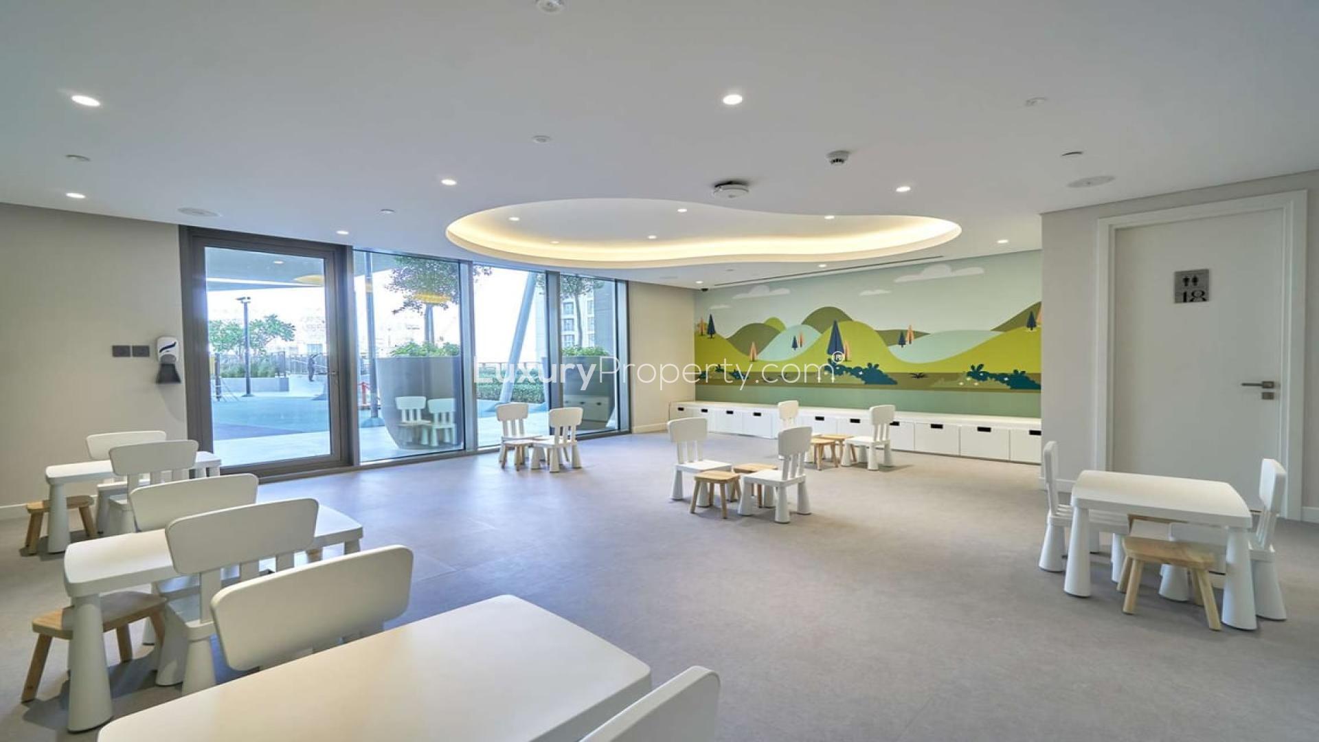 Children's playroom in Creekside 18 apartment, Dubai Creek Harbour, featuring colorful wall mural