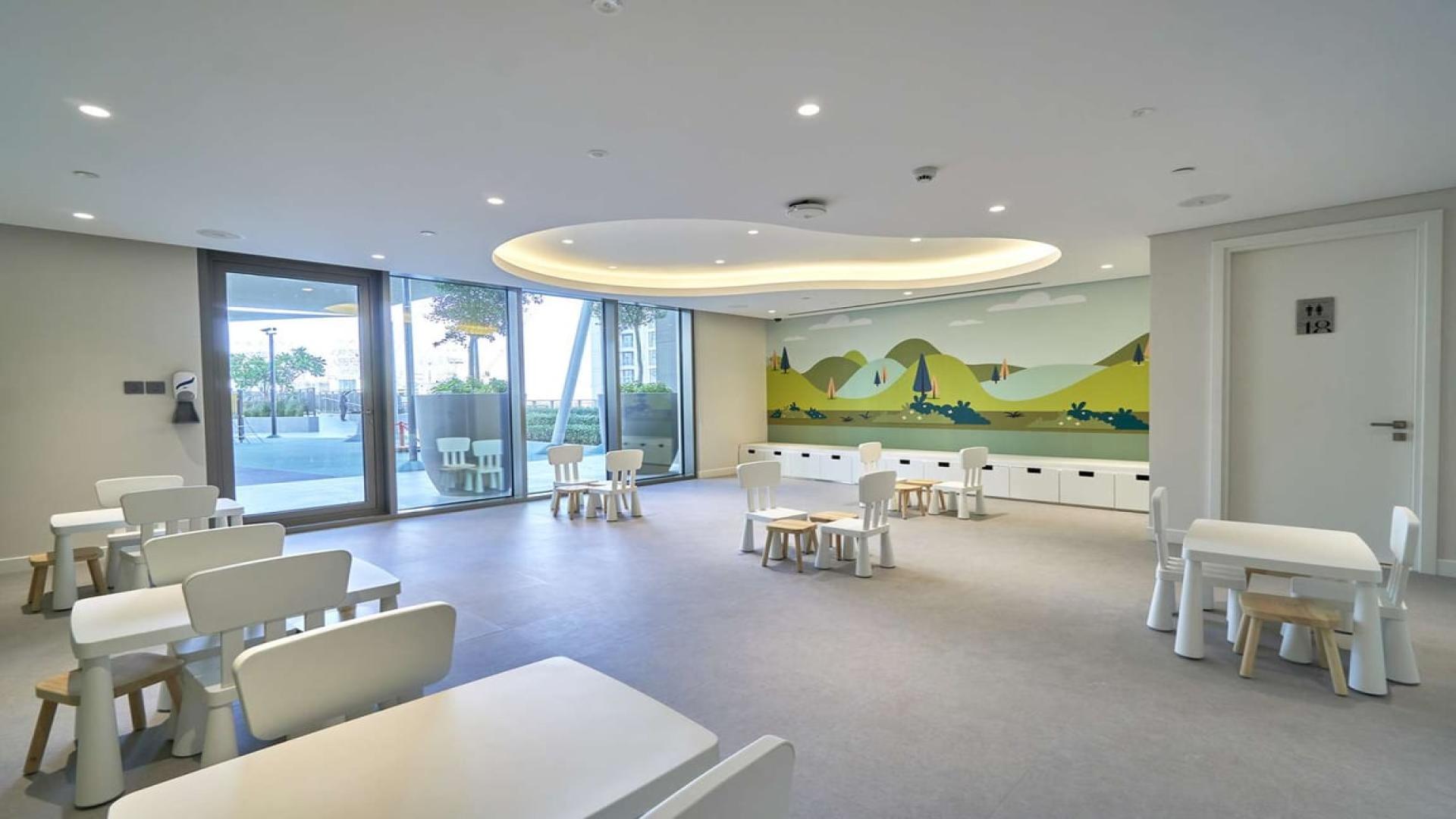 Children's playroom in Creekside 18 apartment, Dubai Creek Harbour, featuring colorful wall mural