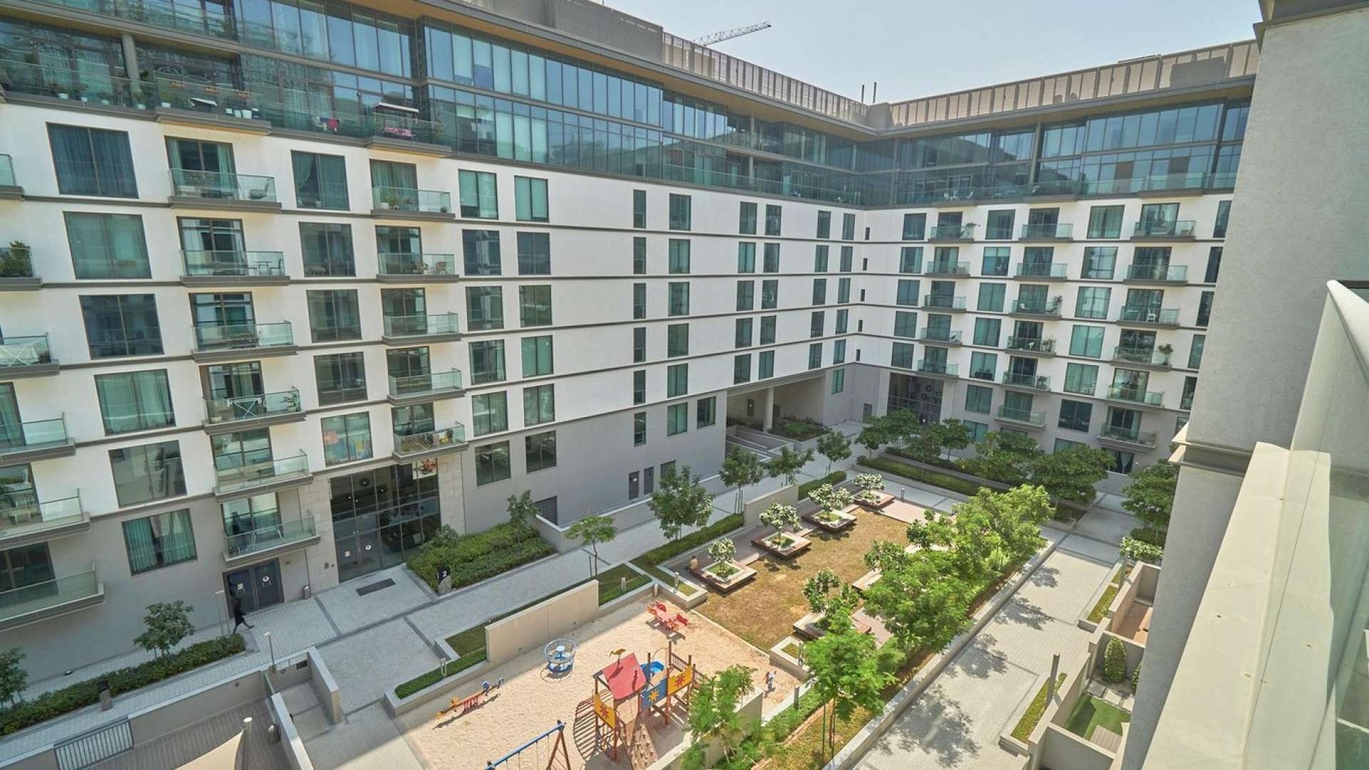 Empty living room with large window in Sobha Hartland apartment, Mohammed Bin Rashid City