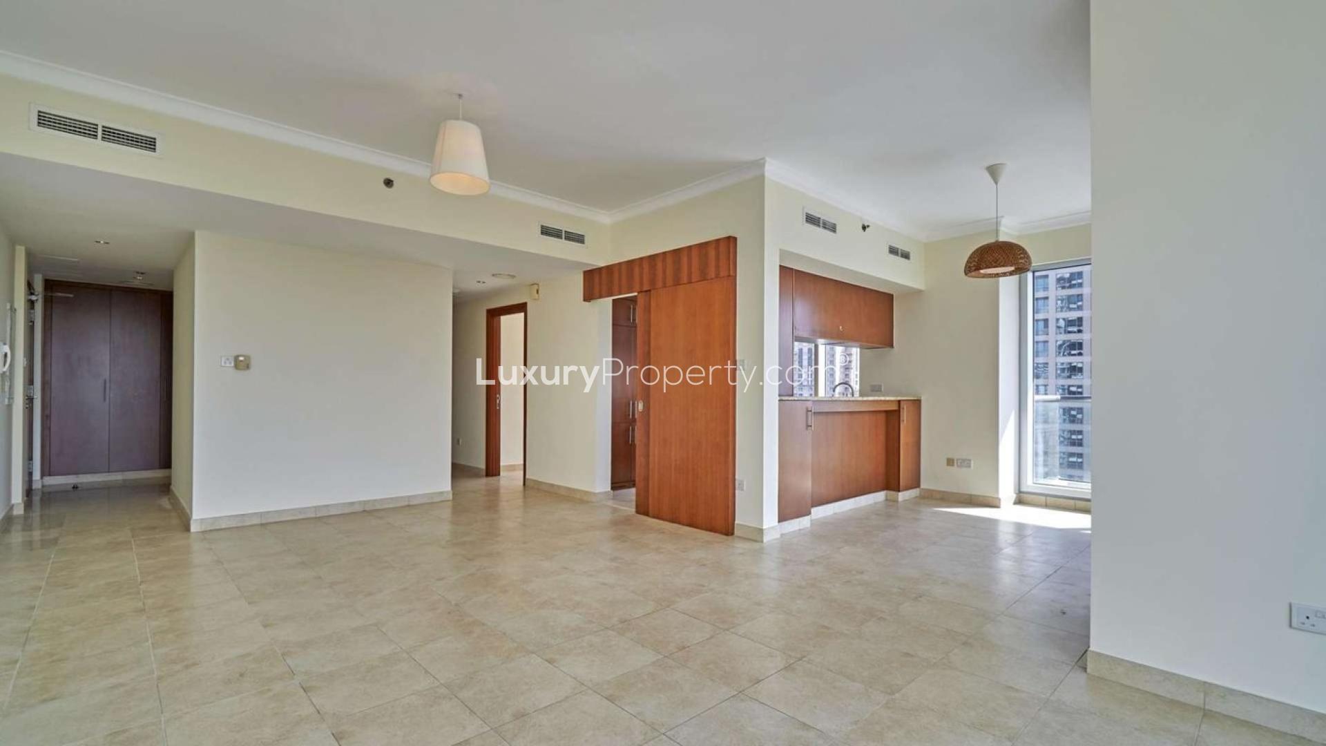 "Balcony view from The Fairways apartment overlooking golf course in The Views community.",Spacious living area in The Fairways two-bedroom apartment, The Views, with natural light