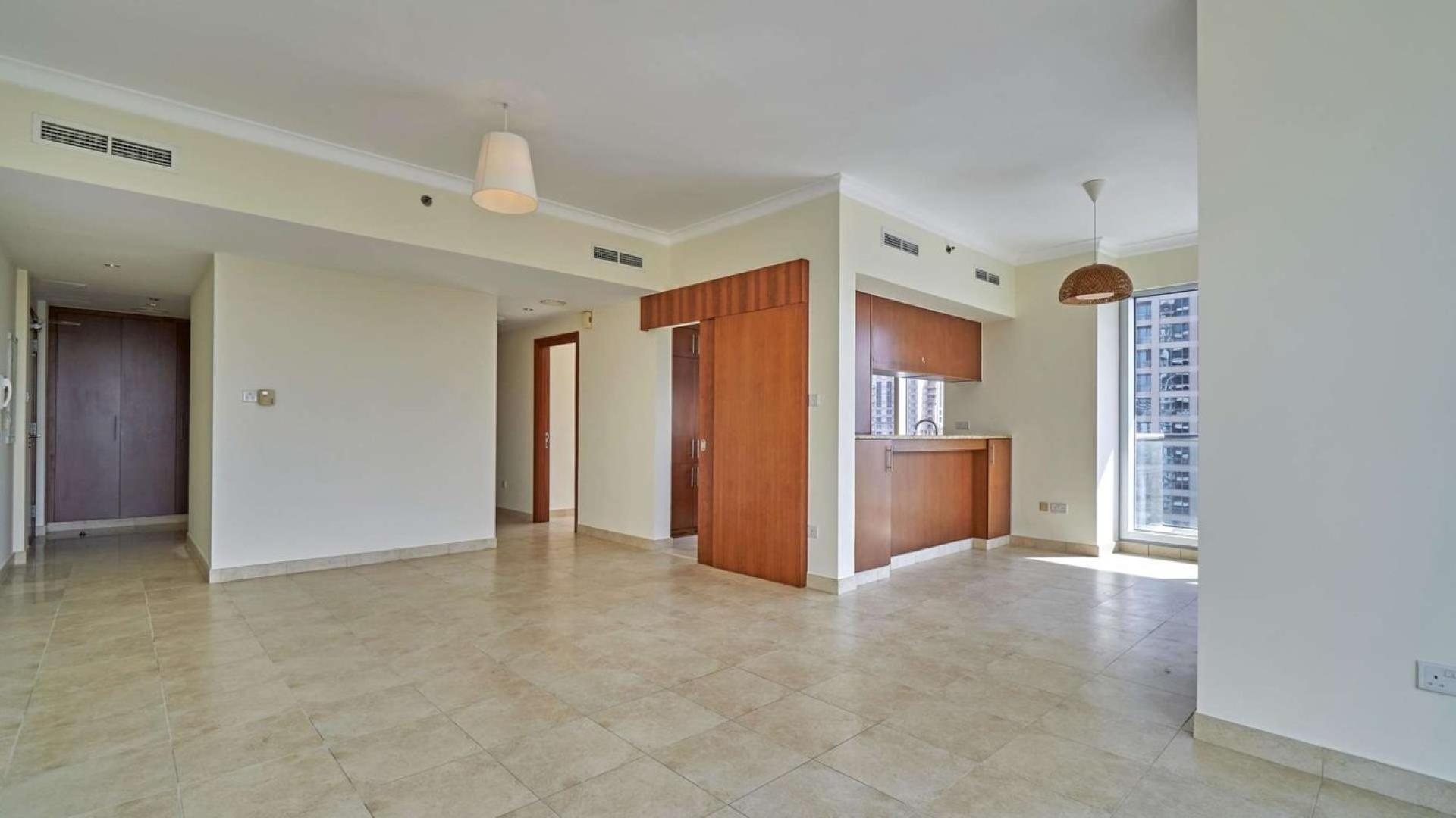 "Balcony view from The Fairways apartment overlooking golf course in The Views community.",Spacious living area in The Fairways two-bedroom apartment, The Views, with natural light
