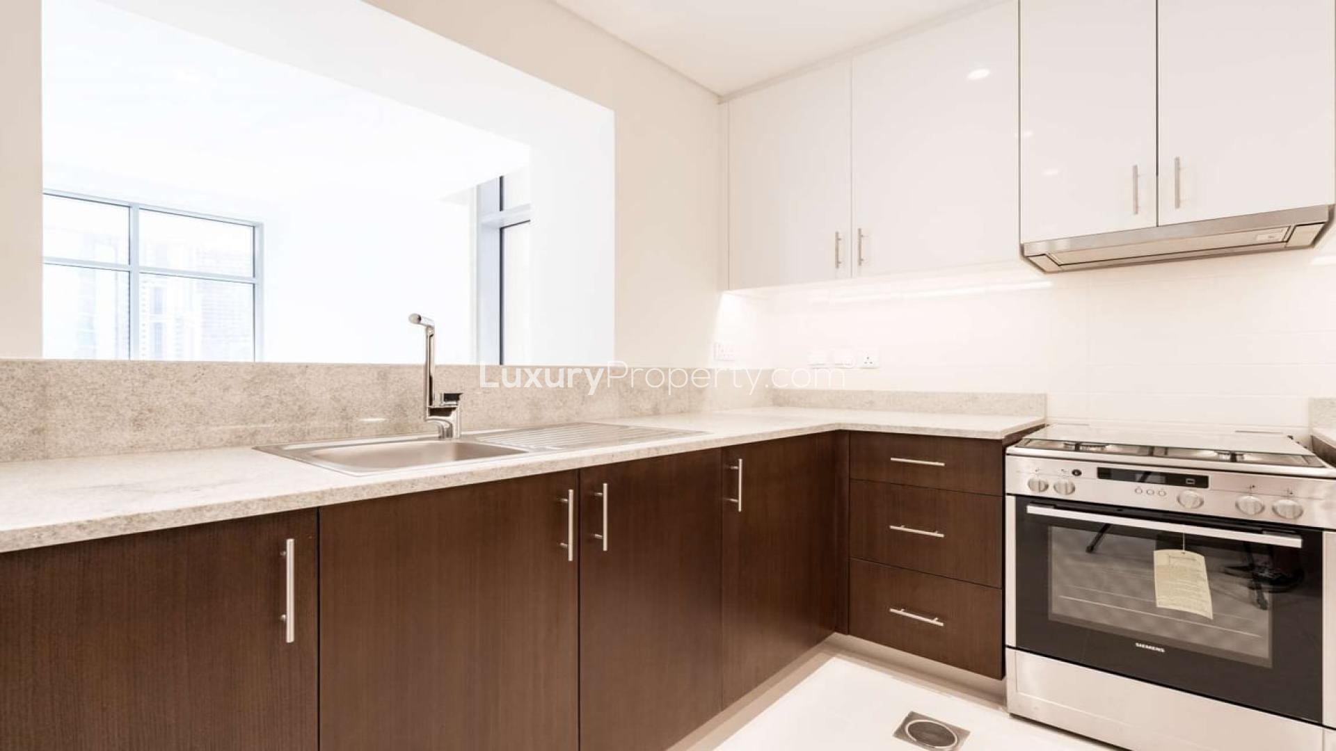 Bright, spacious living room in BLVD Crescent apartment, Downtown Dubai, with large windows