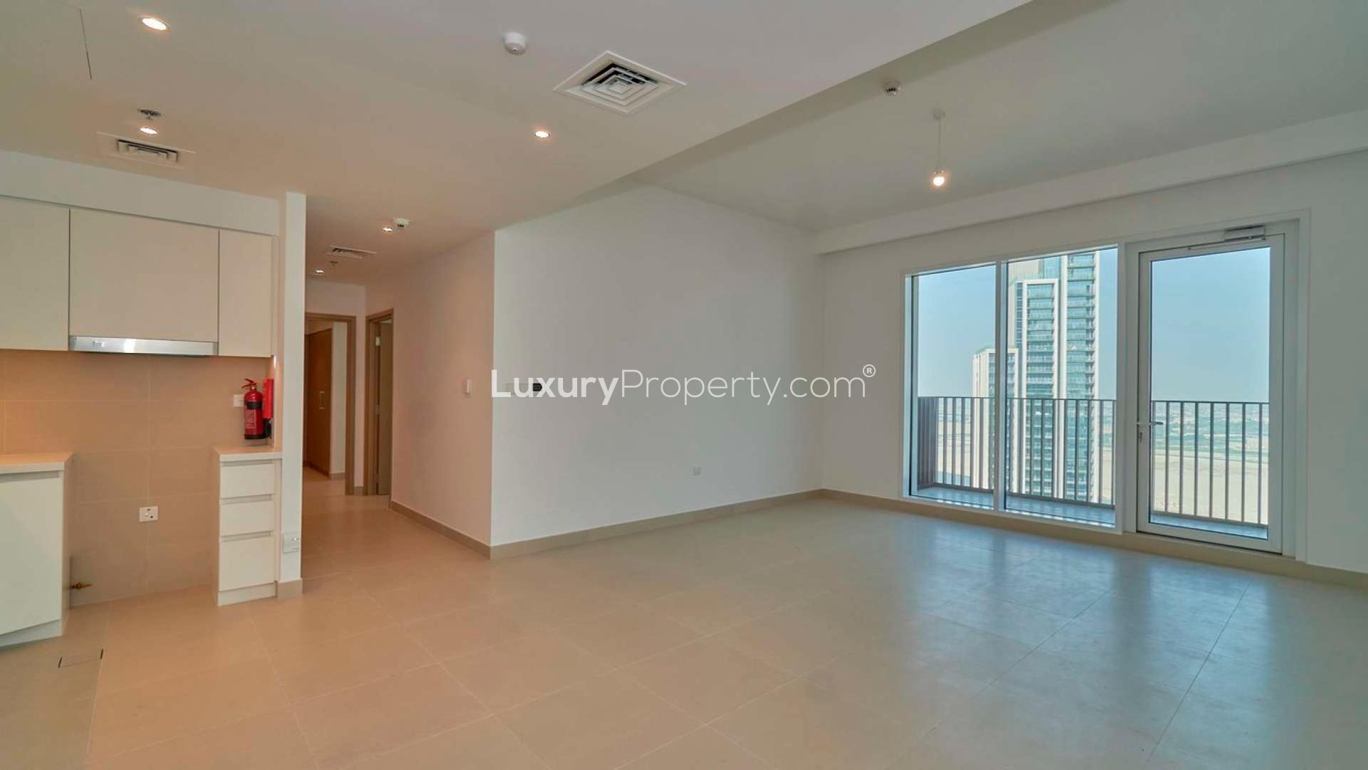 Modern living room with balcony view in Creek Horizon apartment, Dubai Creek Harbour