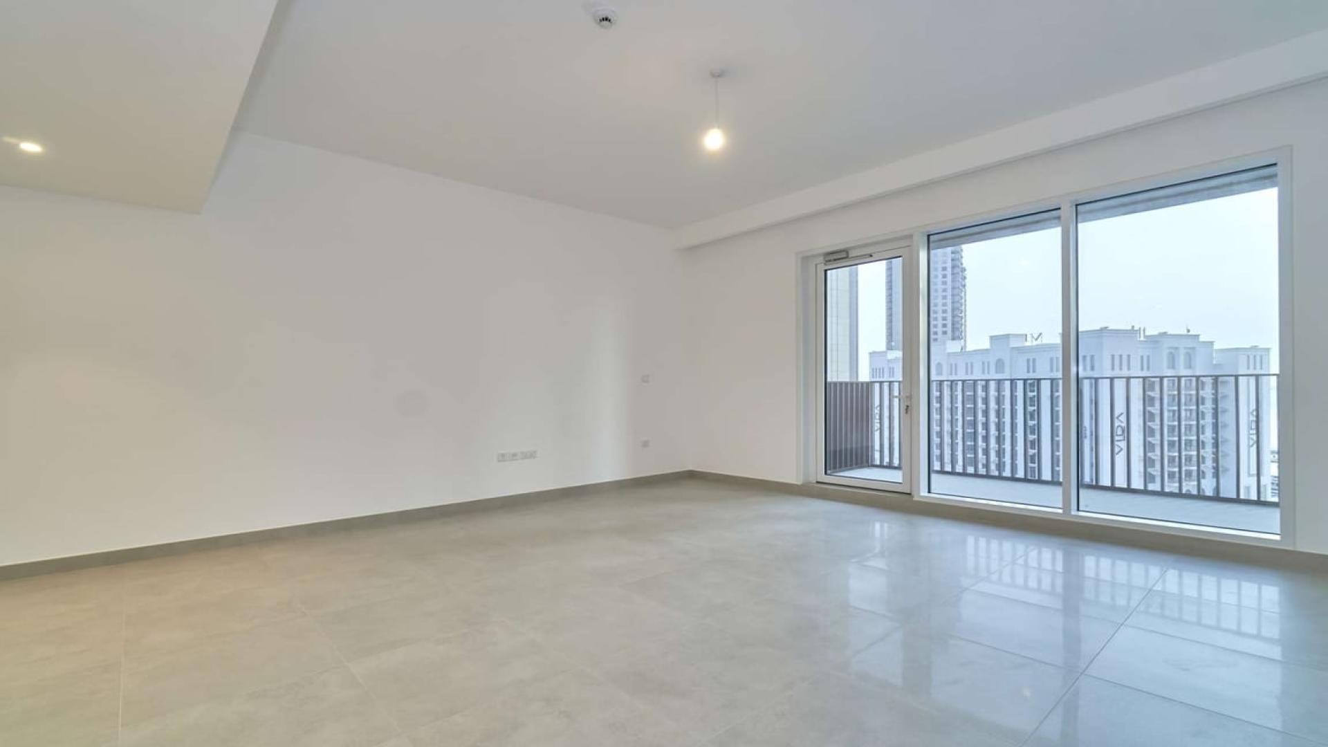 Dubai Creek Harbour apartment view with pool, high-rise buildings, and creek in the background
