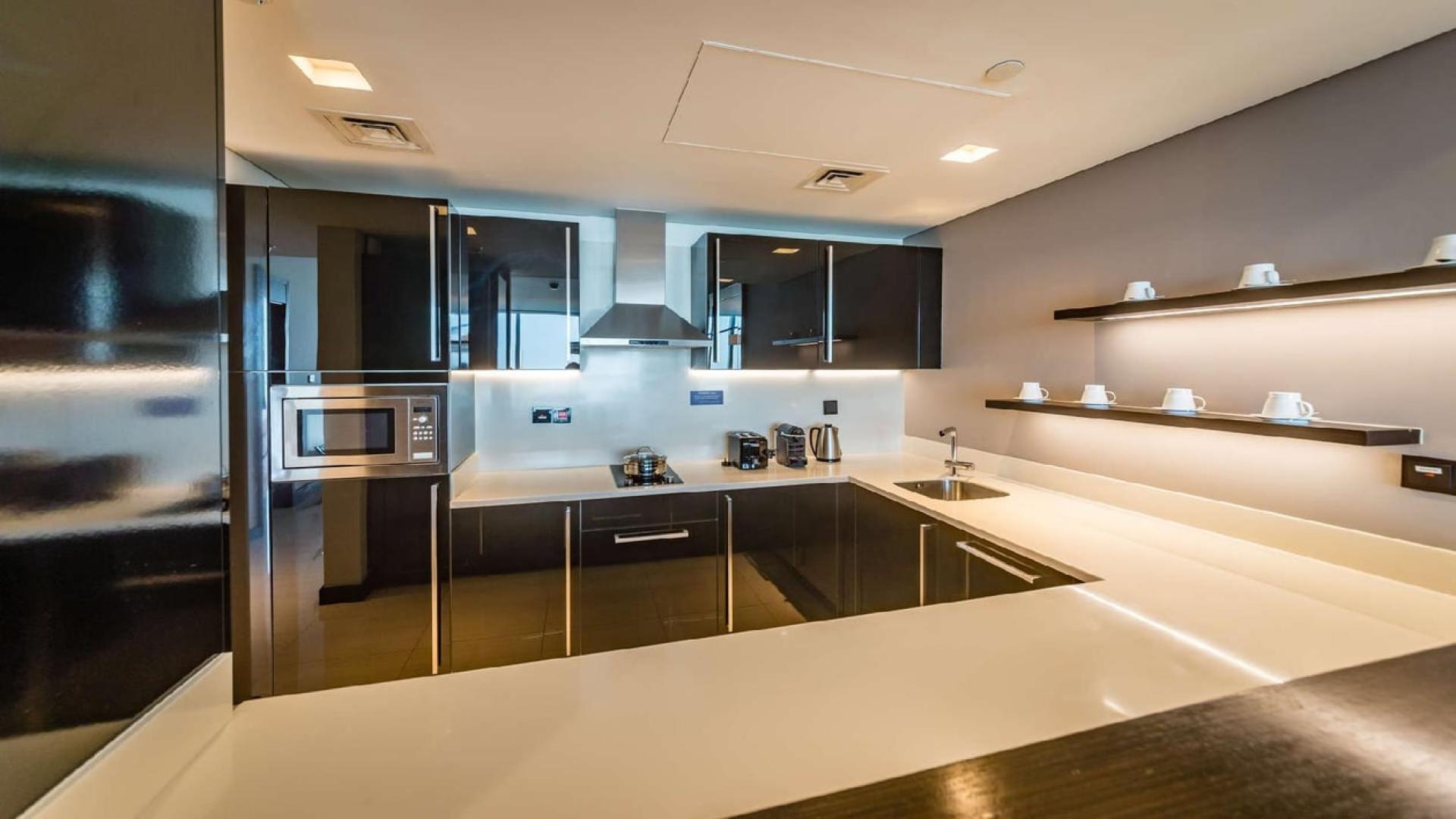 Modern living area in Sheraton Grand Hotel apartment, Sheikh Zayed Road, with sleek kitchen design