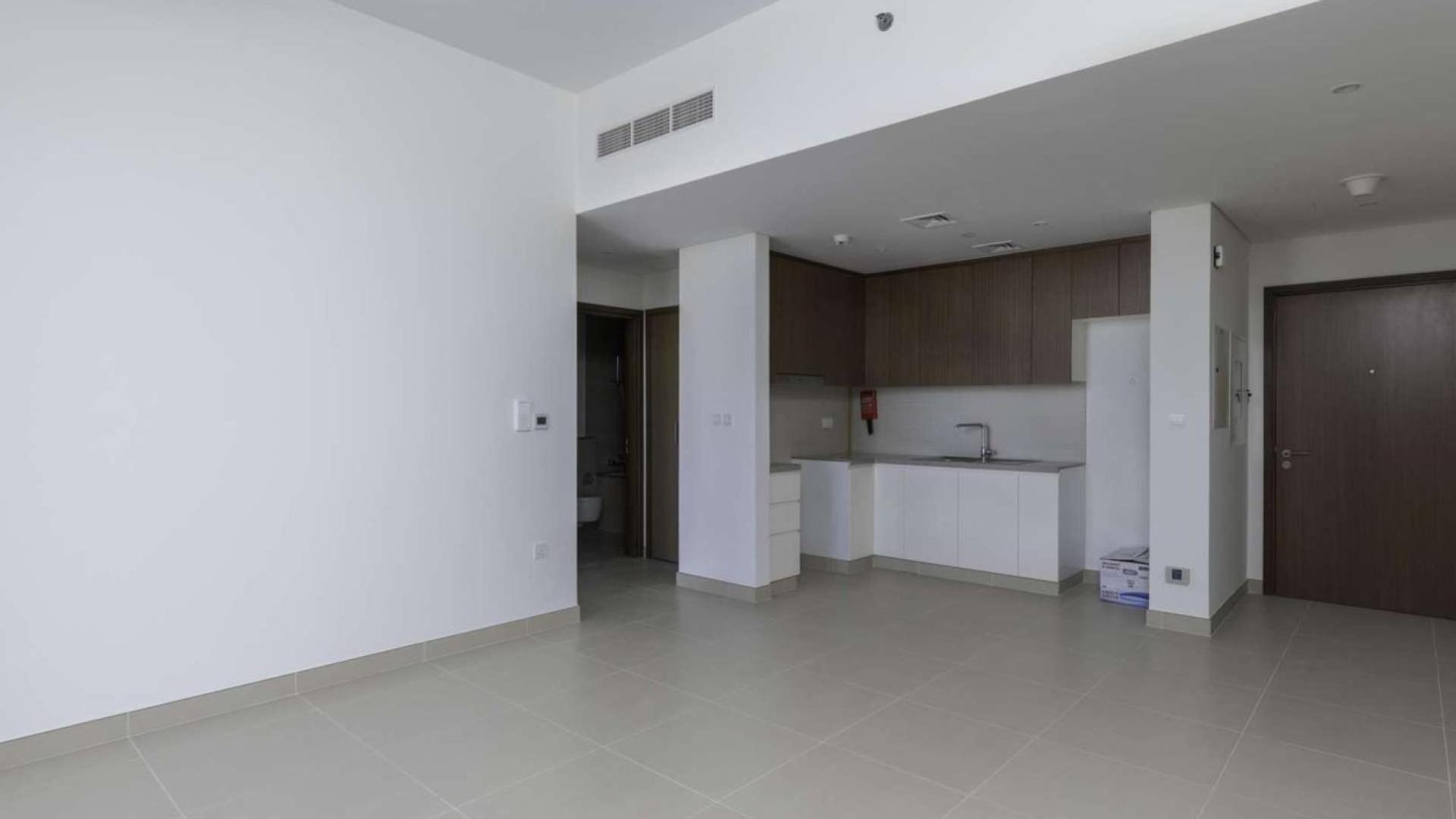 Empty room with large windows and balcony view in Dubai Marina apartment