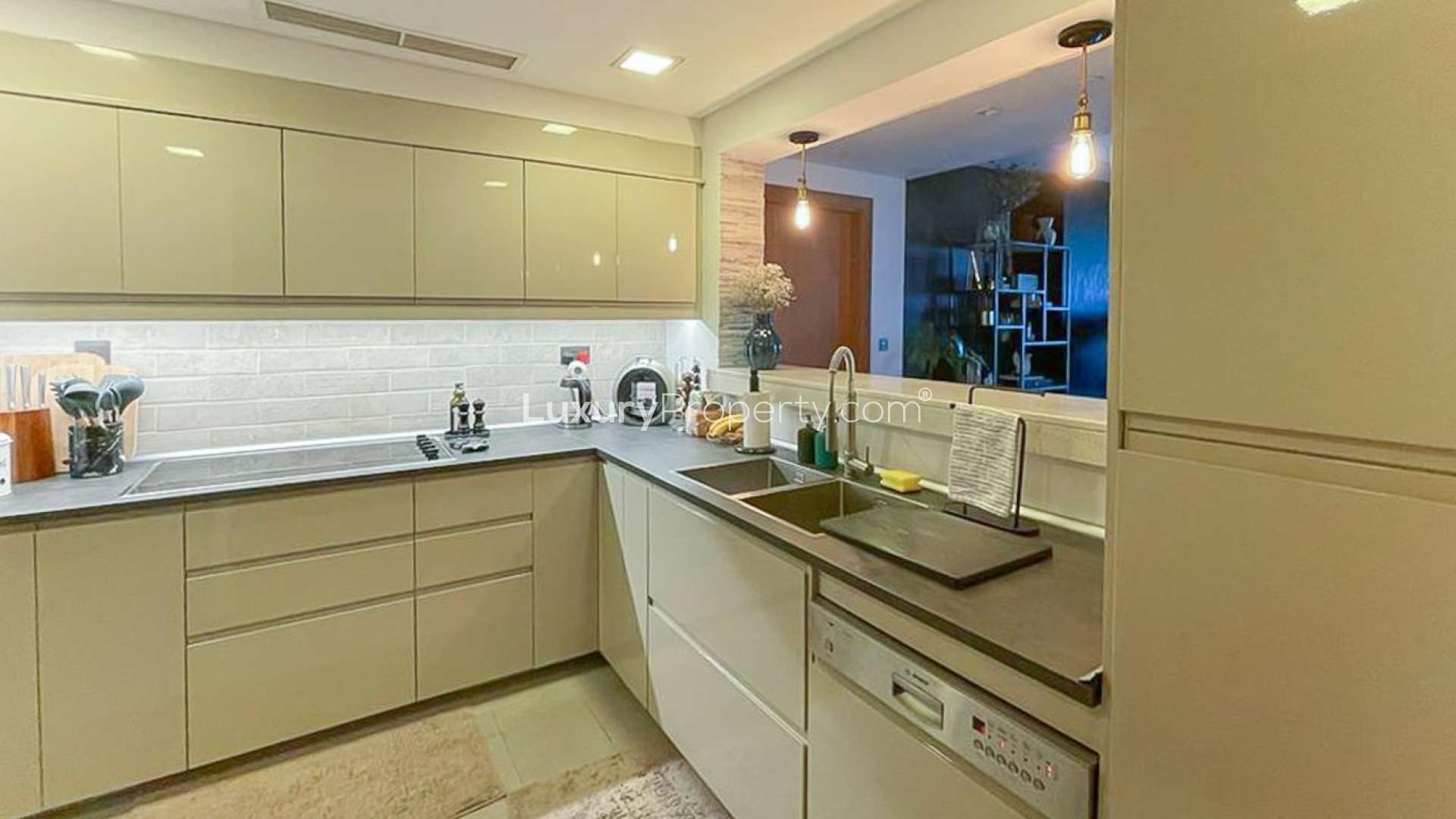 Upgraded kitchen in Palm Jumeirah apartment, Marina Residences, with modern fixtures and ample storage
