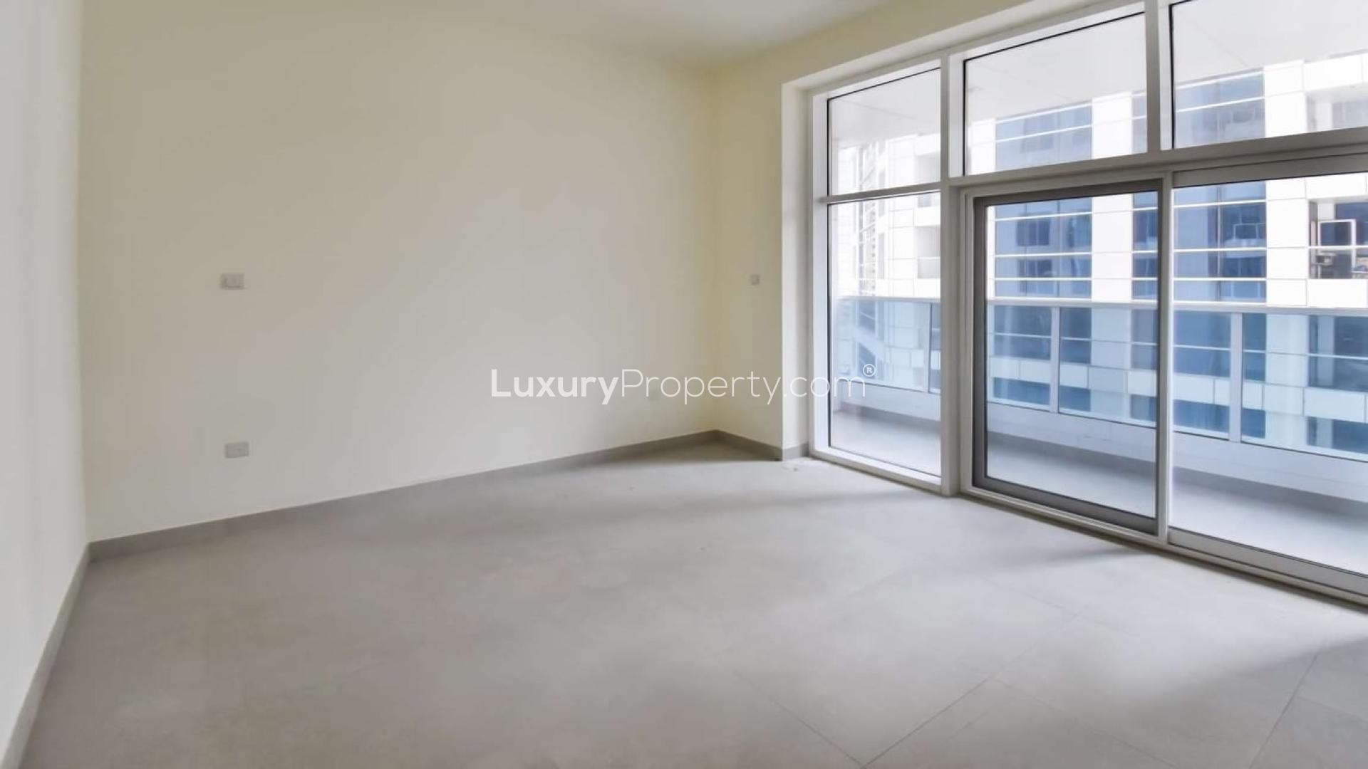 Bright living room in 2-bed Marina Arcade apartment, Dubai Marina, with large windows and balcony