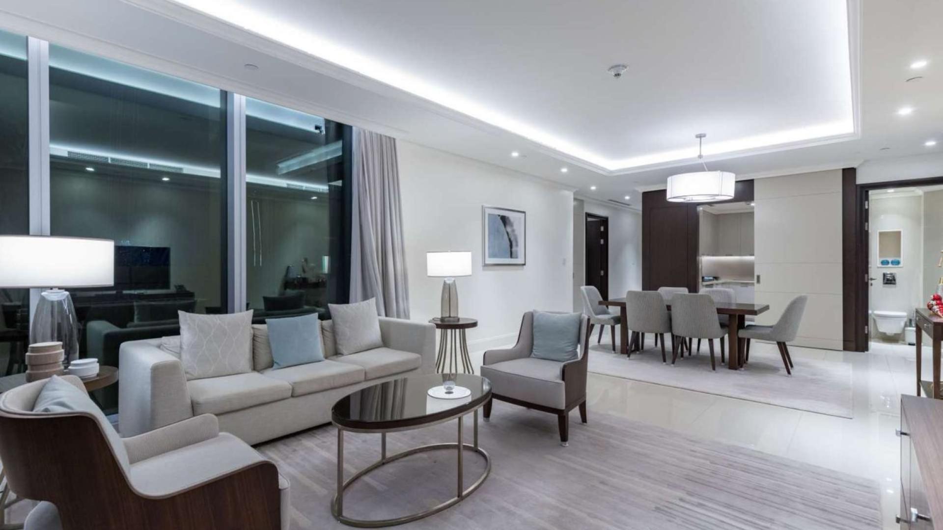 Modern Downtown Dubai apartment living room with elegant furnishings and dining area