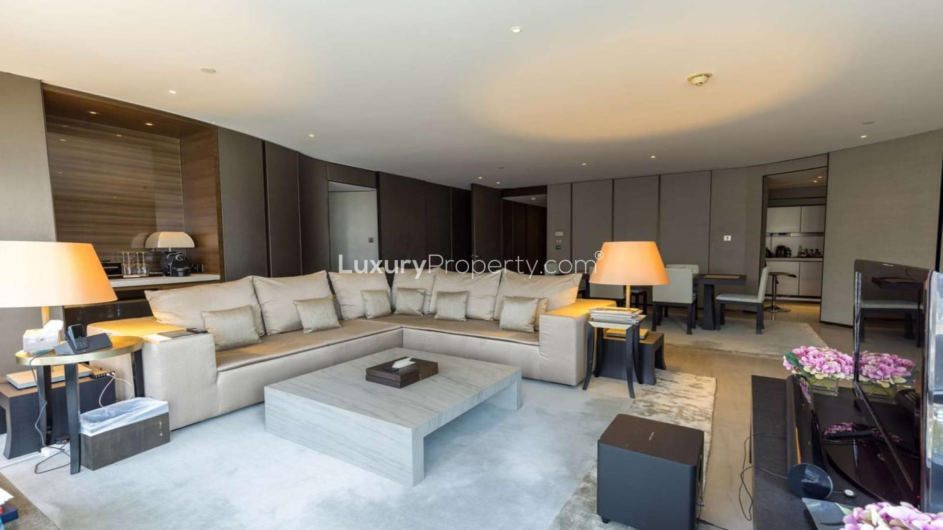 Luxurious Downtown Dubai apartment living room with modern decor, spacious seating, and ambient lighting