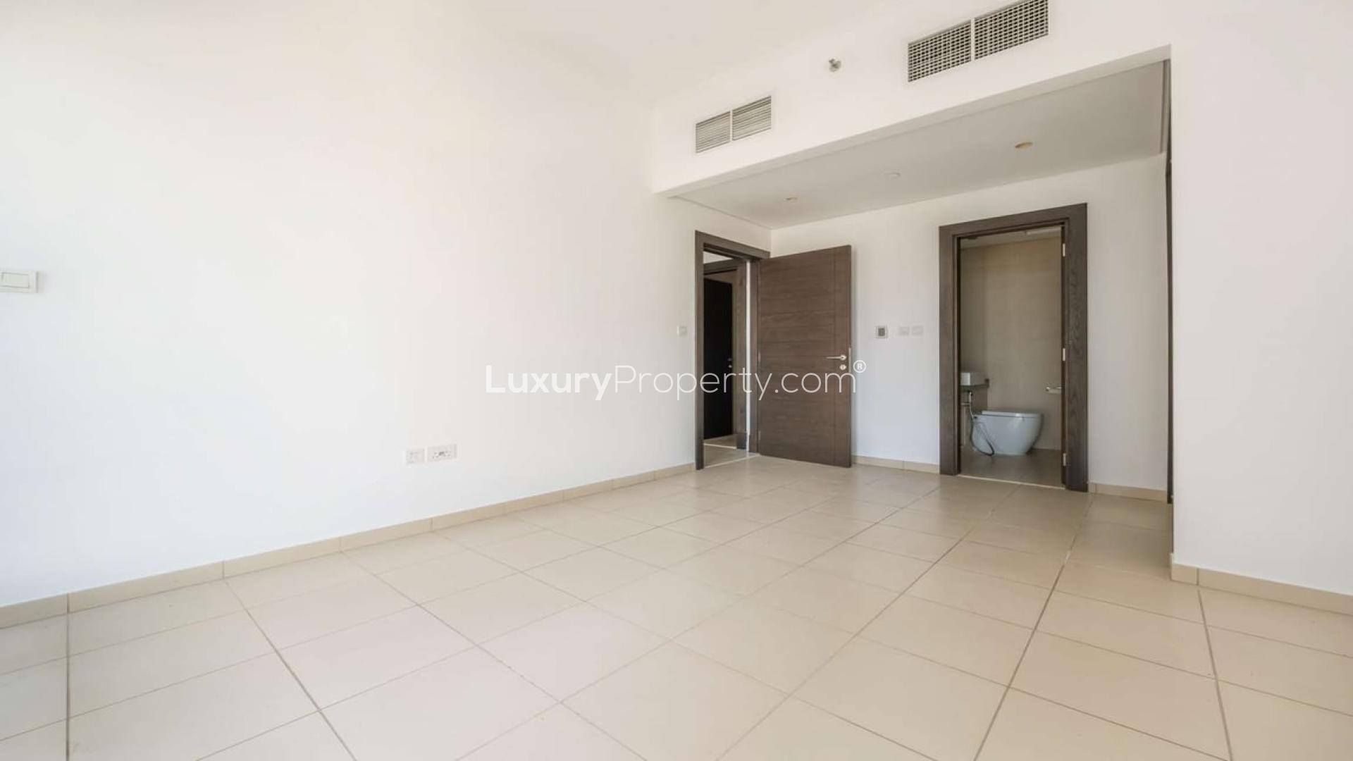 Empty room with tiled floor and open door in Dubai Marina apartment for rent