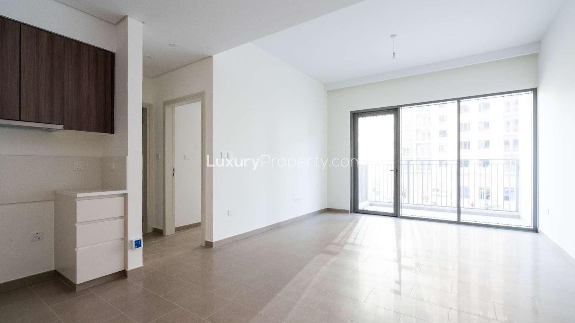 Empty living room with balcony in Dubai Hills Estate apartment for rent