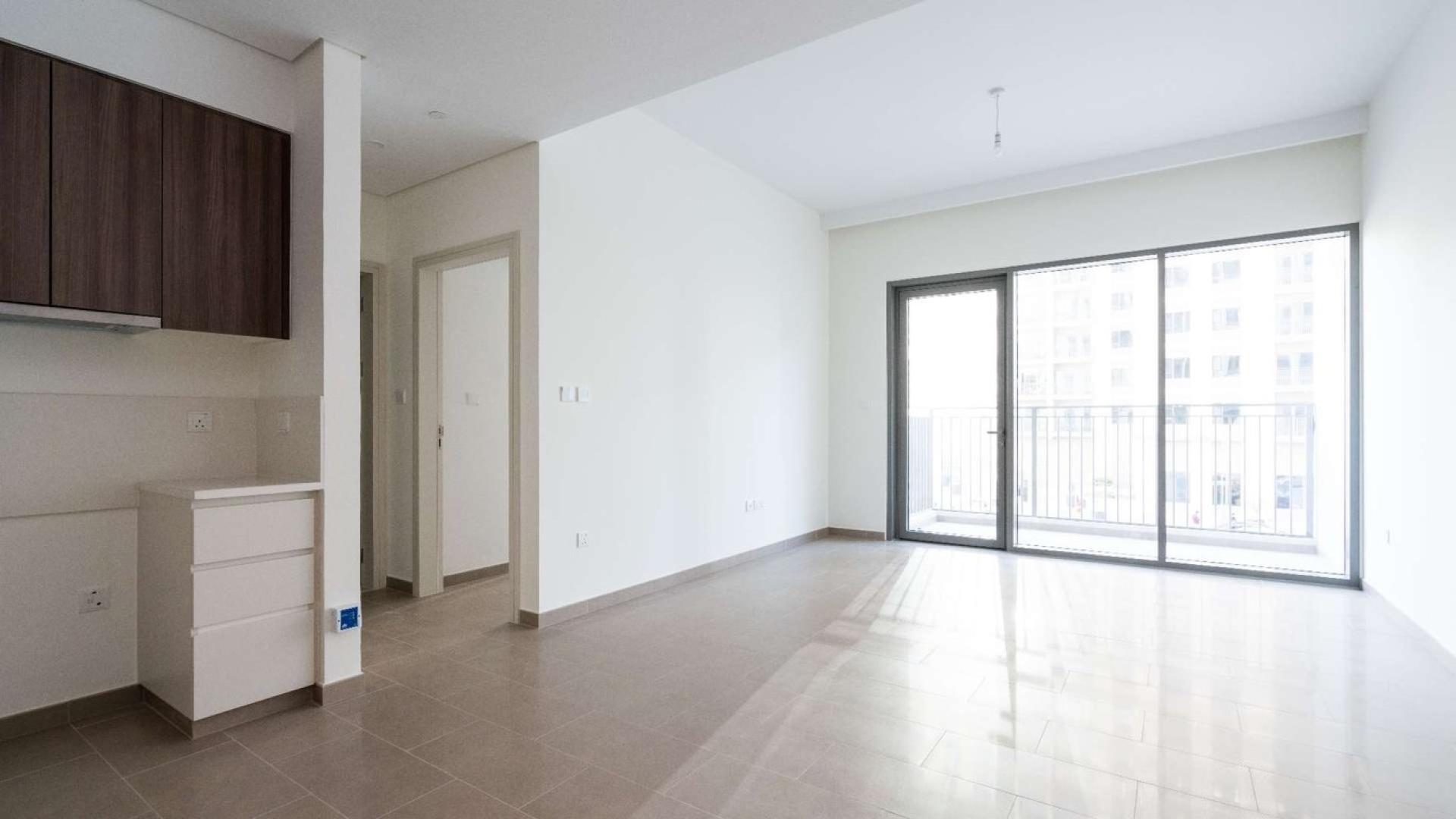 Empty living room with balcony in Dubai Hills Estate apartment for rent