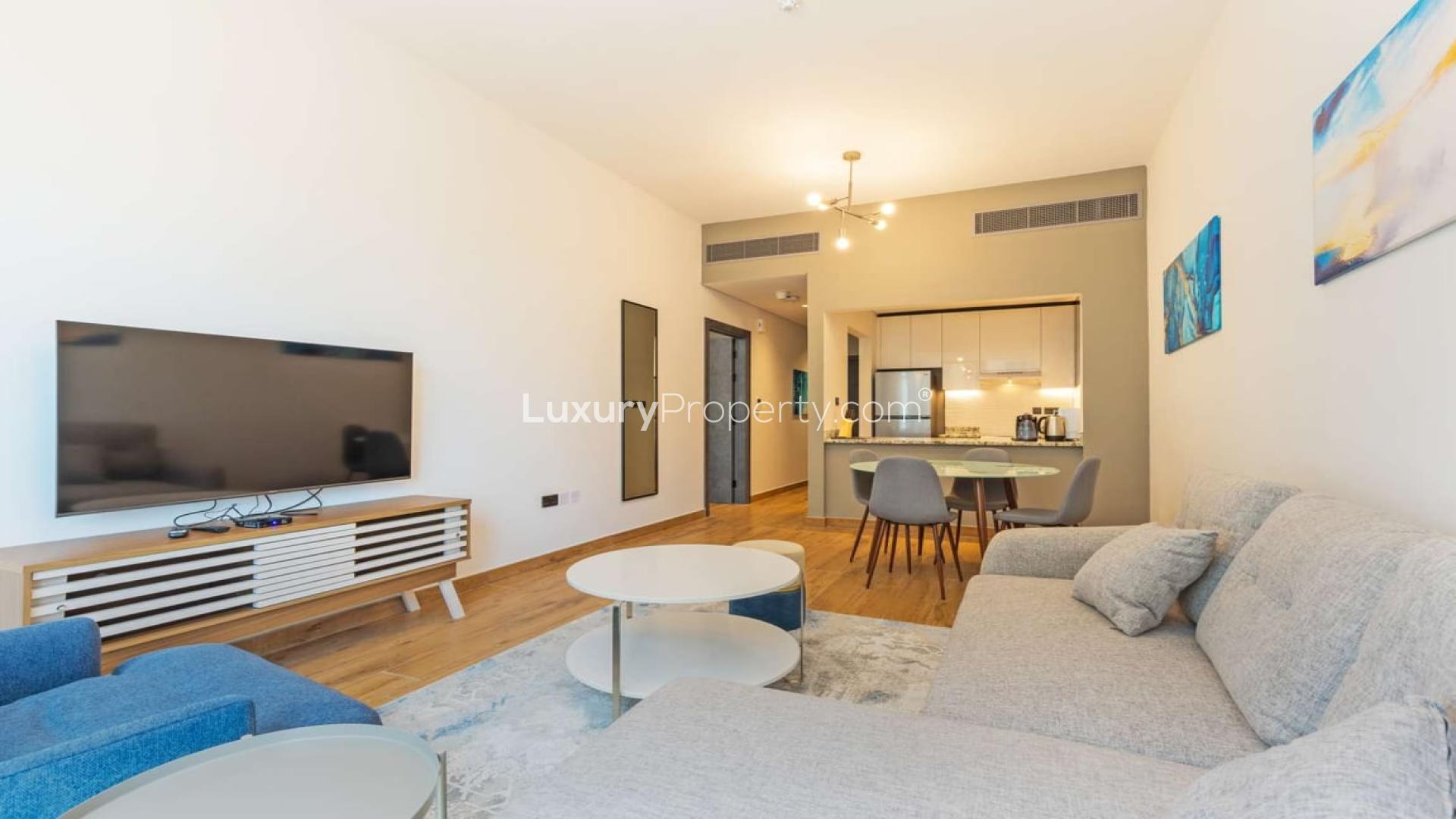 "View from Marina Moon Tower apartment balcony overlooking Dubai Marina skyline and highway.",Modern living room in 1-bedroom apartment, Marina Moon Tower, Dubai Marina, for rent