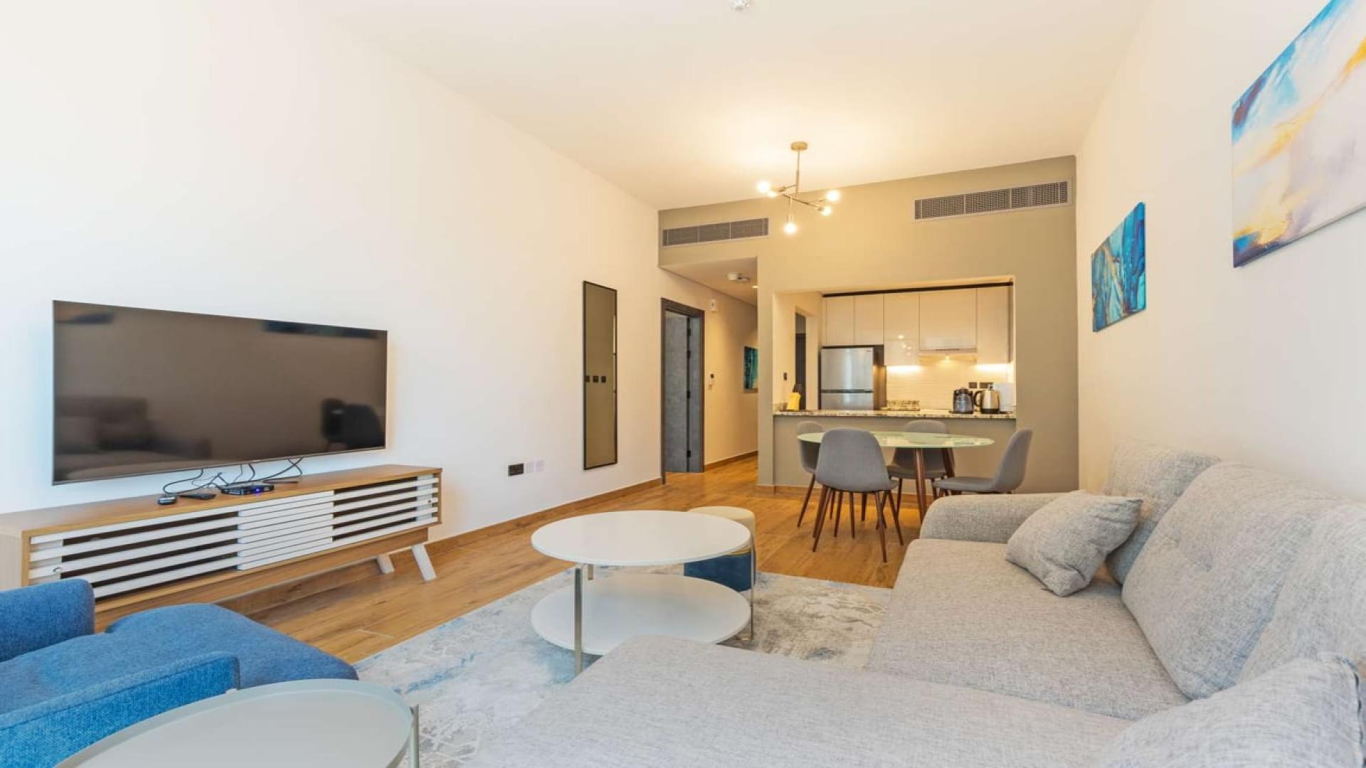 "View from Marina Moon Tower apartment balcony overlooking Dubai Marina skyline and highway.",Modern living room in 1-bedroom apartment, Marina Moon Tower, Dubai Marina, for rent