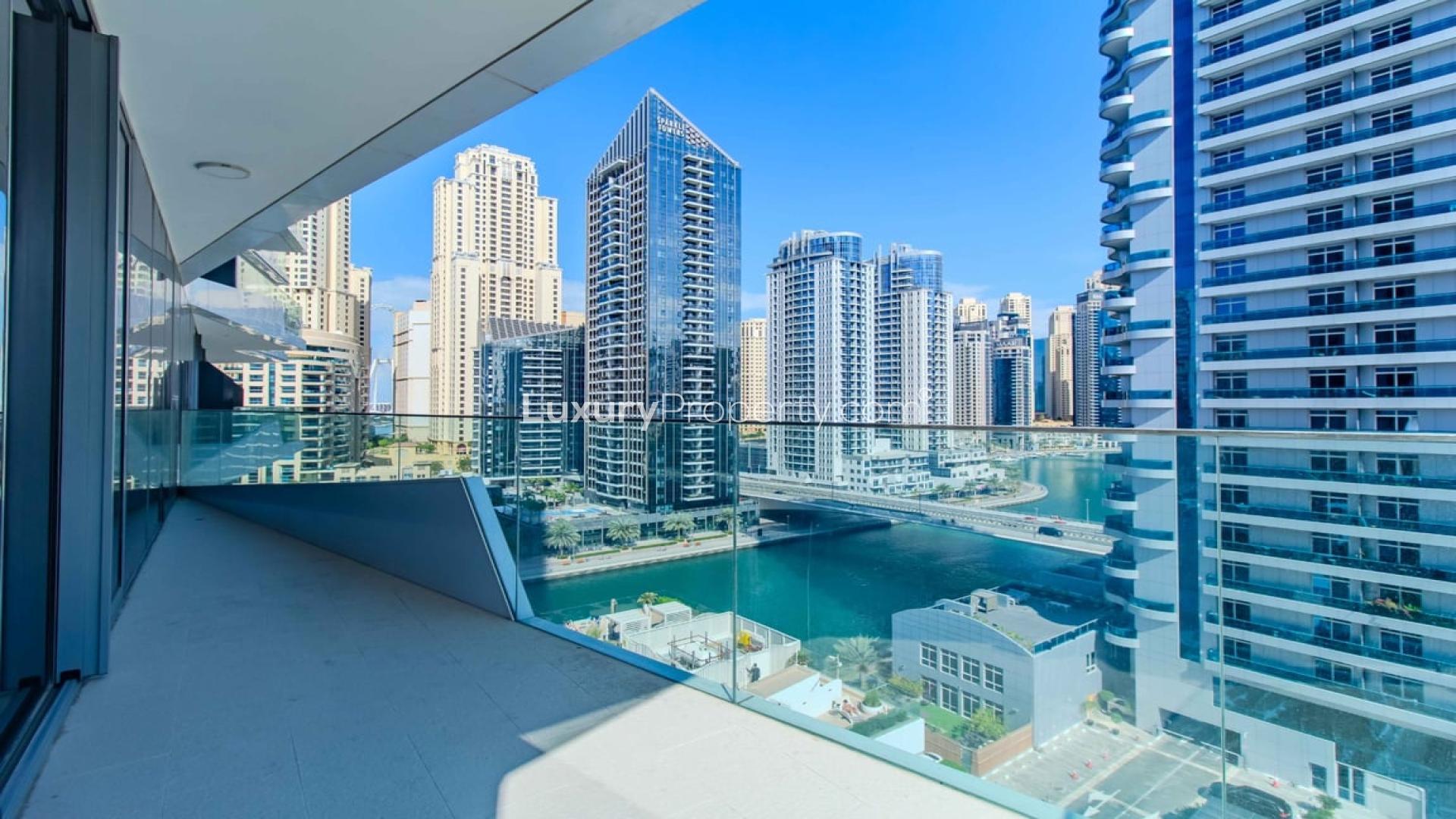 "Spacious living room with floor-to-ceiling windows, offering stunning Dubai Marina views, Stella Maris.",Luxurious apartment balcony with stunning Dubai Marina sea view, Stella Maris community