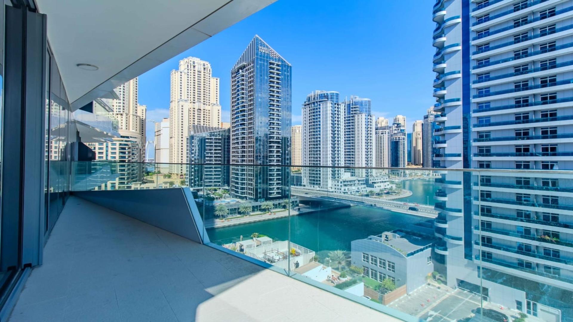 "Spacious living room with floor-to-ceiling windows, offering stunning Dubai Marina views, Stella Maris.",Luxurious apartment balcony with stunning Dubai Marina sea view, Stella Maris community