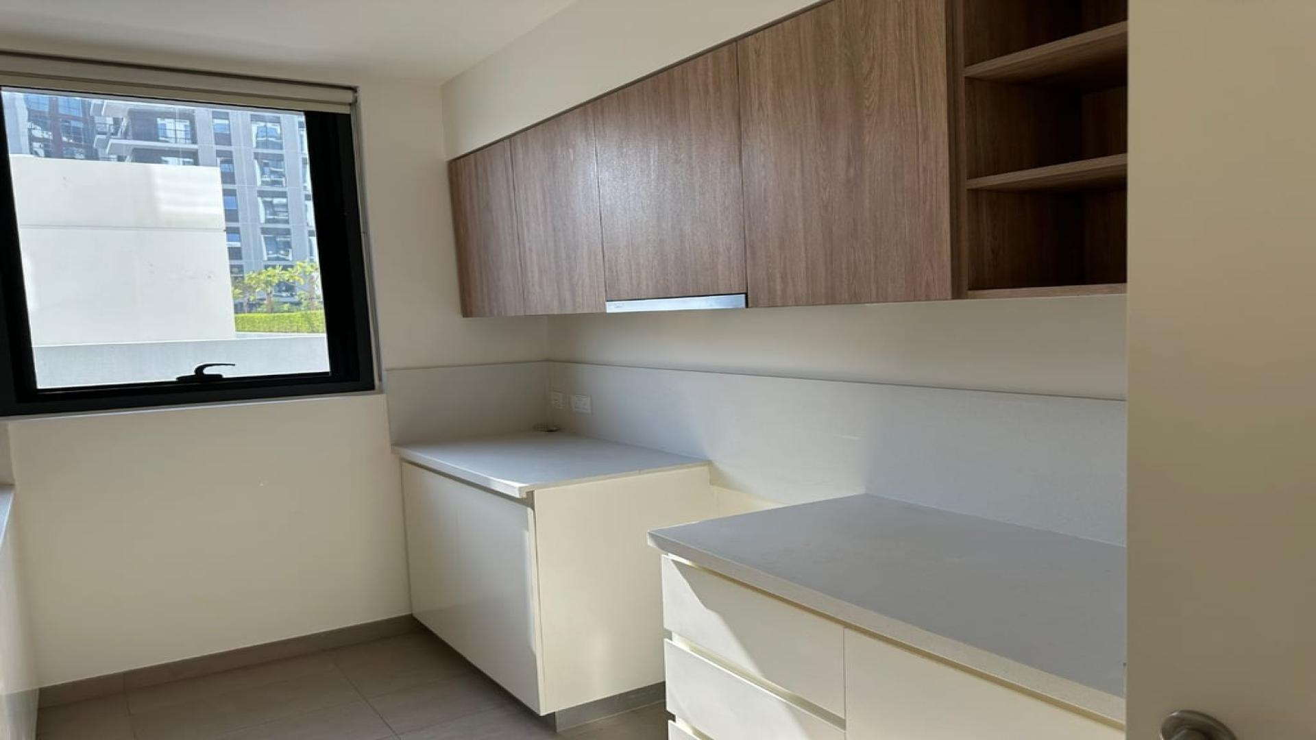 Spacious park-facing living room in vacant Dubai Hills Estate apartment for rent, Executive Residences
