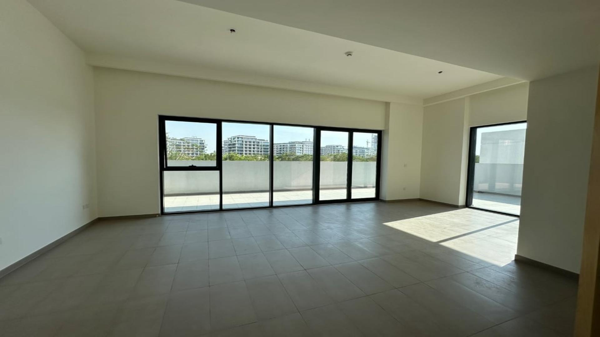Spacious, sunlit living area in vacant Dubai Hills Estate apartment, park-facing with large windows