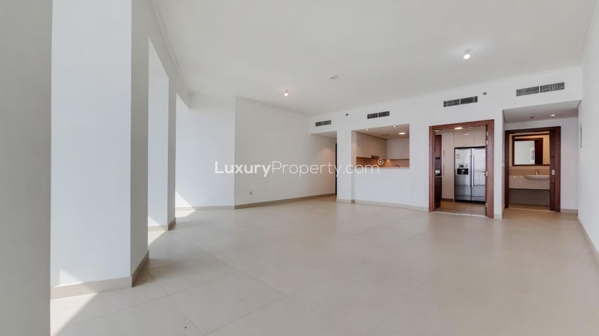 "Balcony view of Dubai skyline from Burj Vista apartment in Downtown Dubai for rent.",Vacant living area in Burj Vista 2-bedroom apartment, Downtown Dubai, with kitchen view