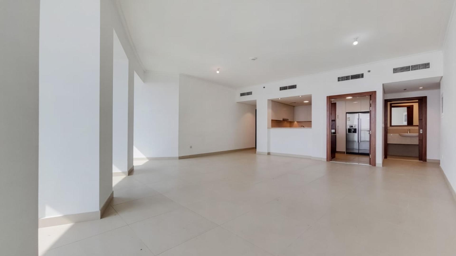 "Balcony view of Dubai skyline from Burj Vista apartment in Downtown Dubai for rent.",Vacant living area in Burj Vista 2-bedroom apartment, Downtown Dubai, with kitchen view