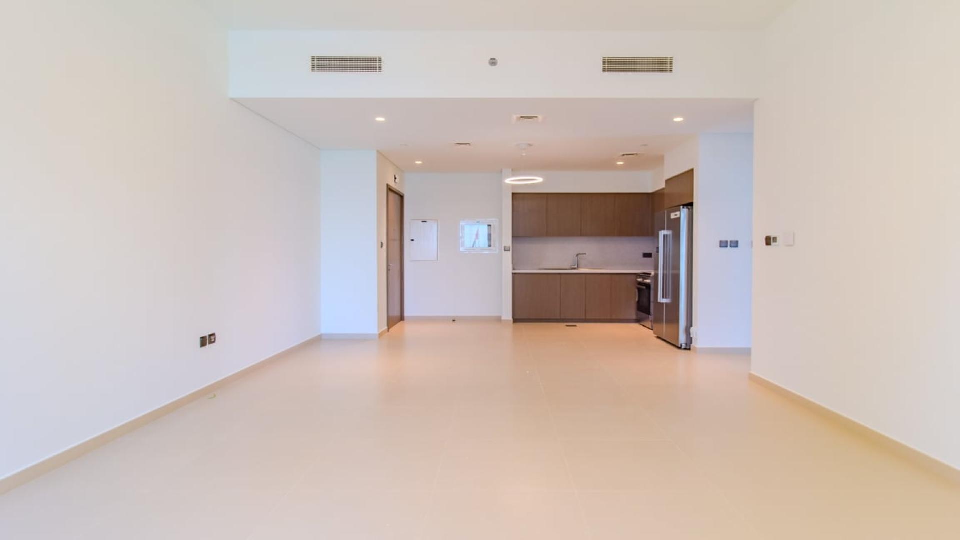 Modern apartment in Downtown Dubai with city views through large windows, featuring elegant lighting