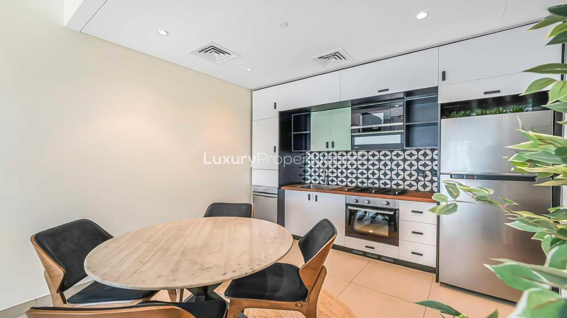 Modern kitchen and dining area in Socio Tower, Dubai Hills Estate apartment for rent