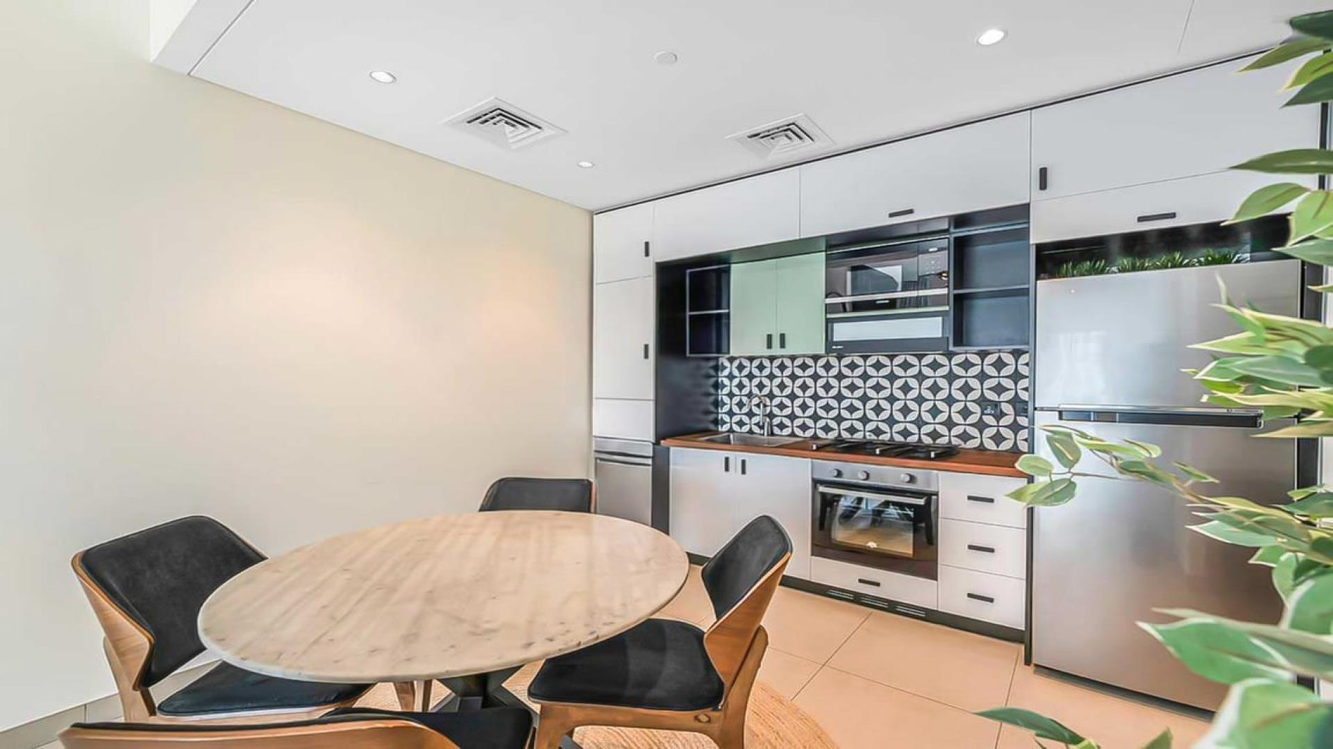 Modern kitchen and dining area in Socio Tower, Dubai Hills Estate apartment for rent