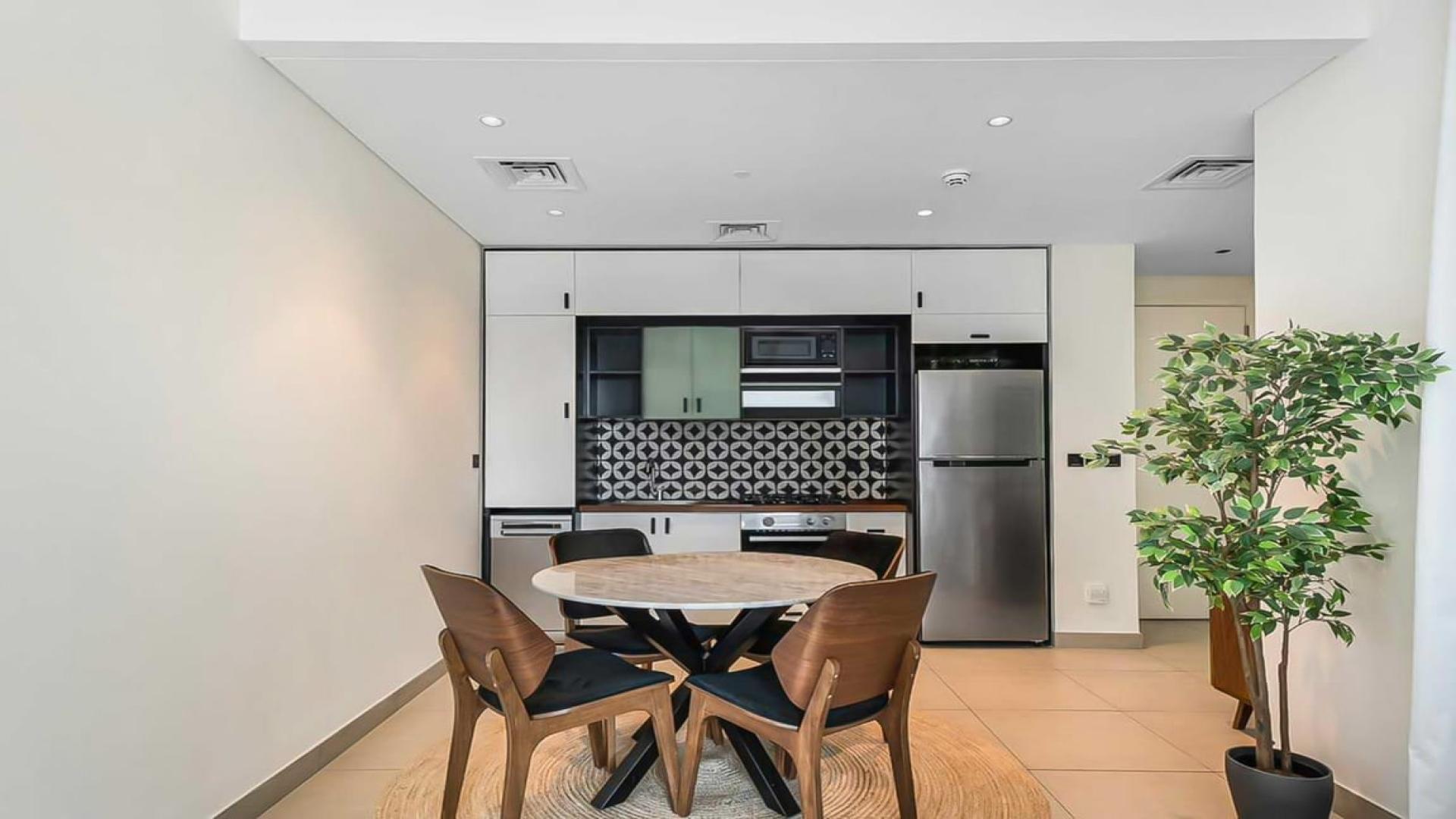 Furnished apartment living area with modern kitchen in Socio Tower, Dubai Hills Estate