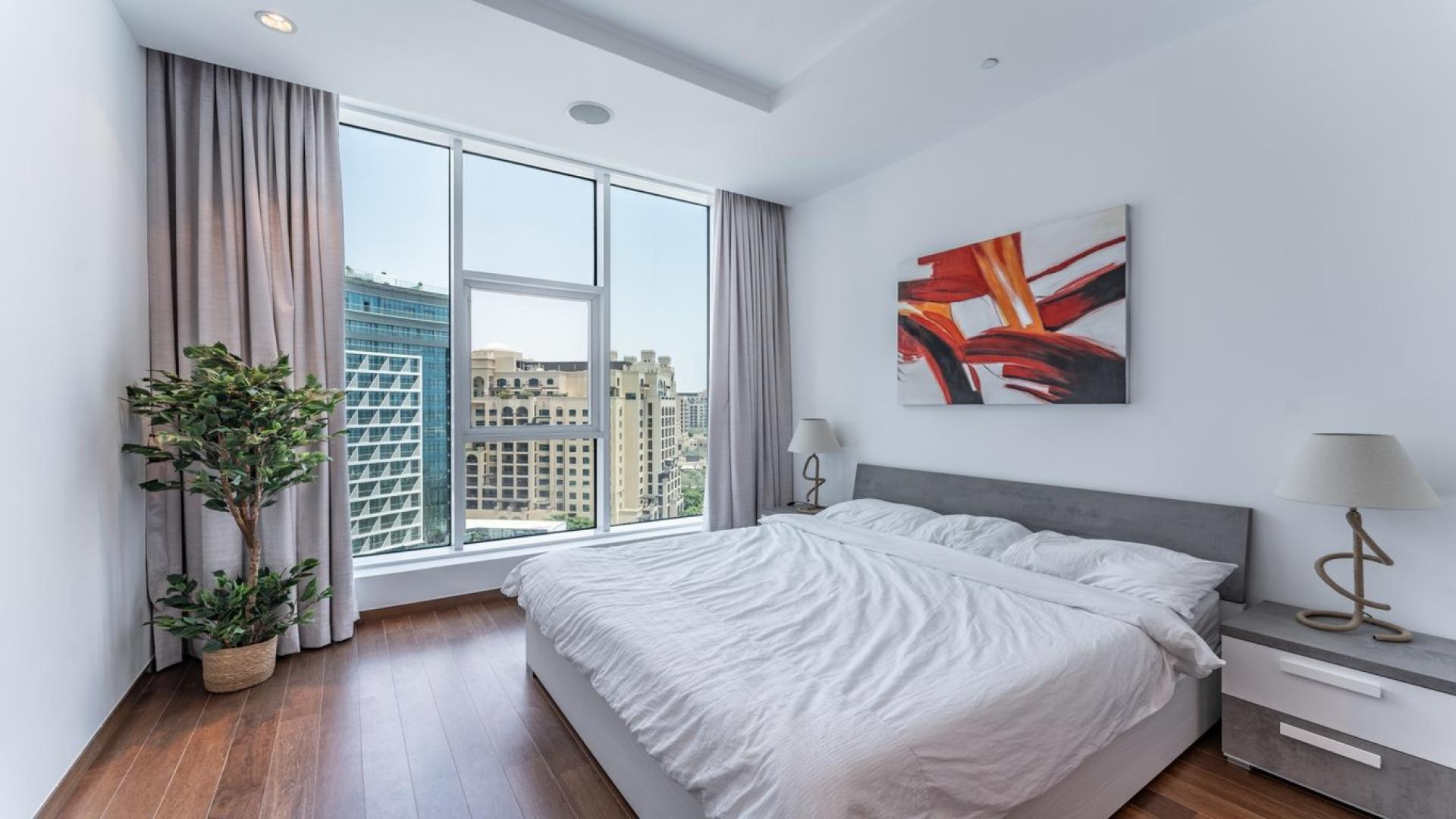 Modern furnished living room in Palm Jumeirah apartment, featuring large windows and stylish decor