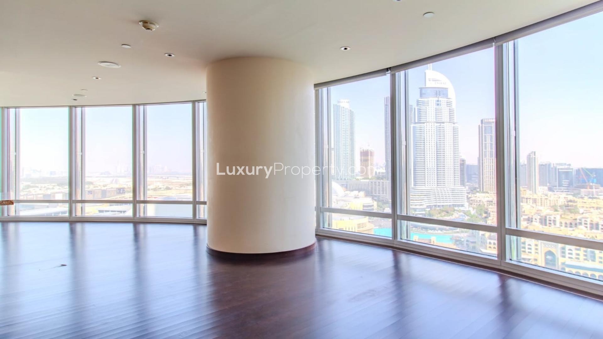High-floor apartment with panoramic city views, large windows, and wooden flooring in Burj Khalifa