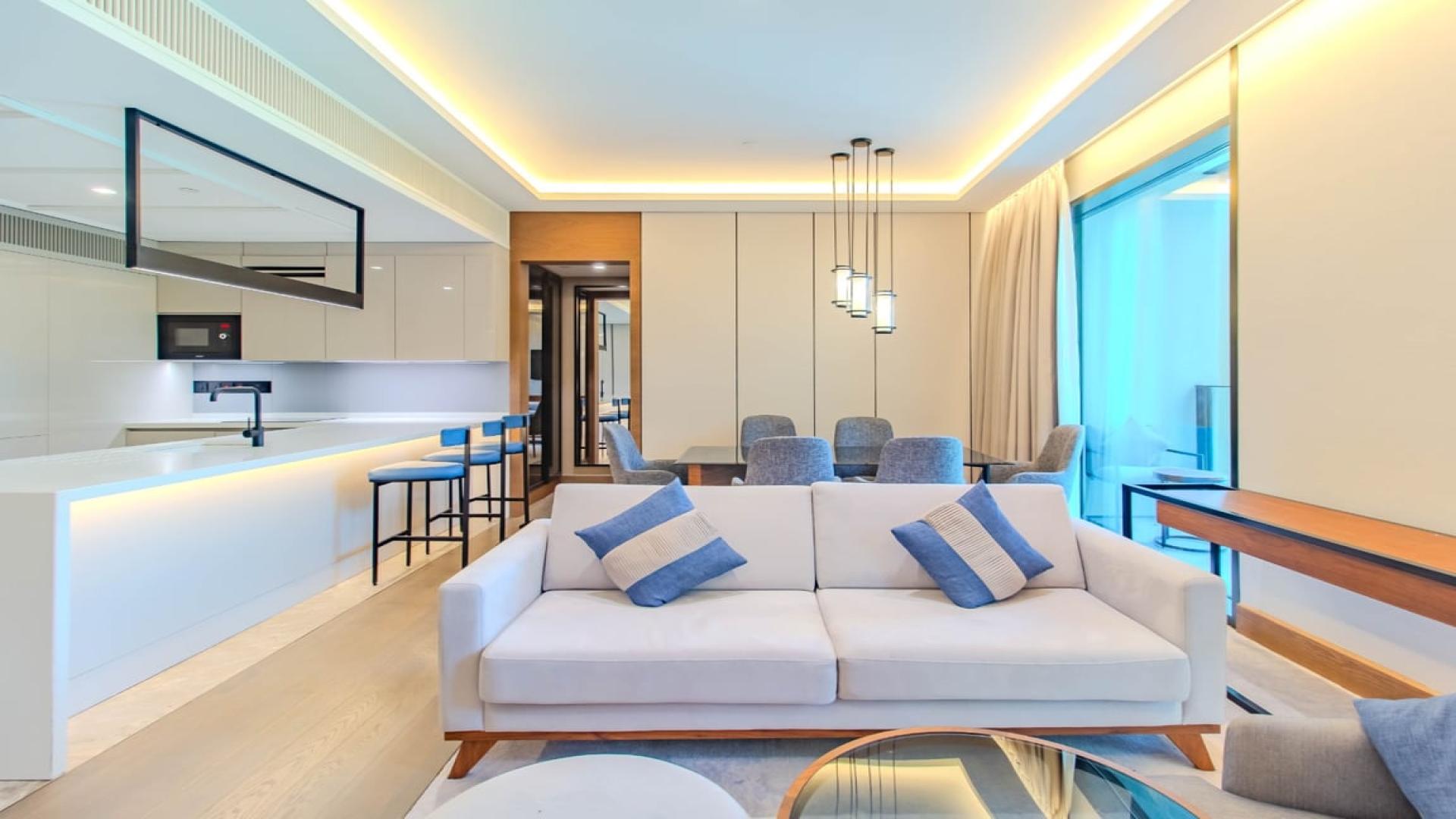 Modern living room in two-bedroom apartment, Caesars Bluewaters Dubai, featuring elegant furnishings