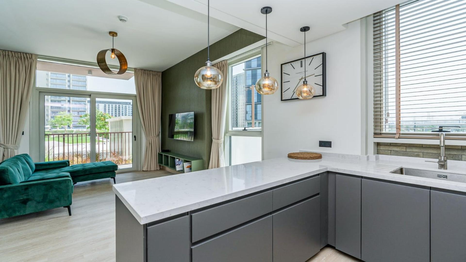 Modern kitchen in fully furnished Dubai Hills Estate apartment for rent, featuring sleek design