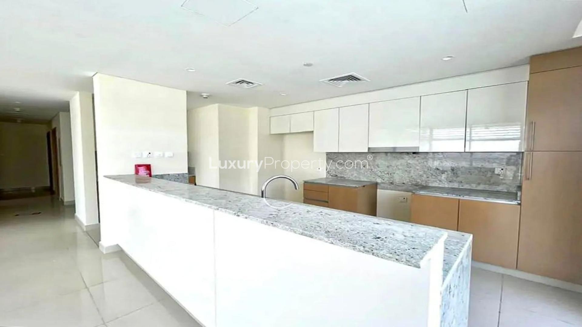 Unfurnished living area with open kitchen in Dubai Hills Estate apartment for rent
