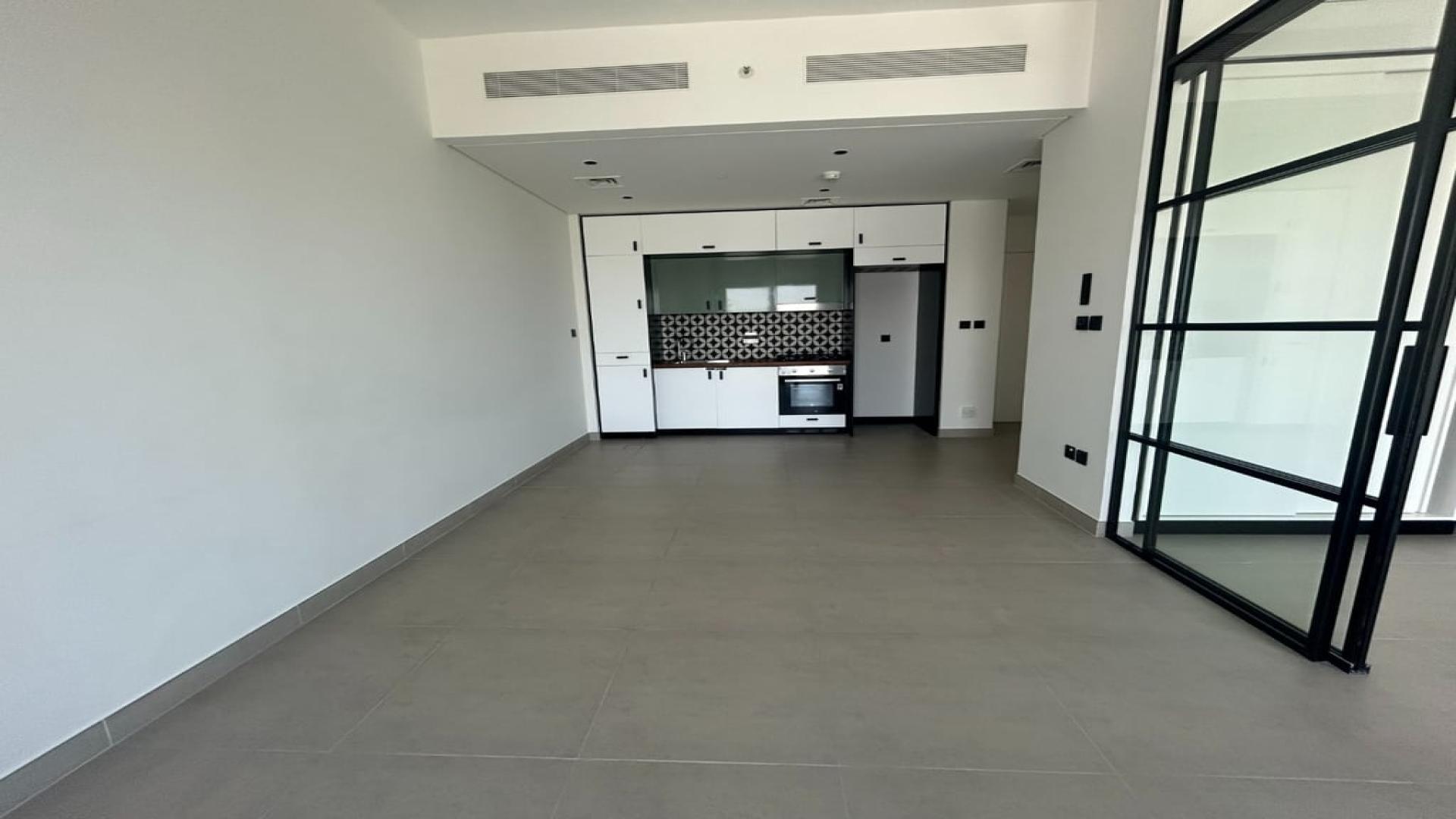 Unfurnished high-floor apartment in Dubai Hills Estate, featuring modern kitchen and spacious layout