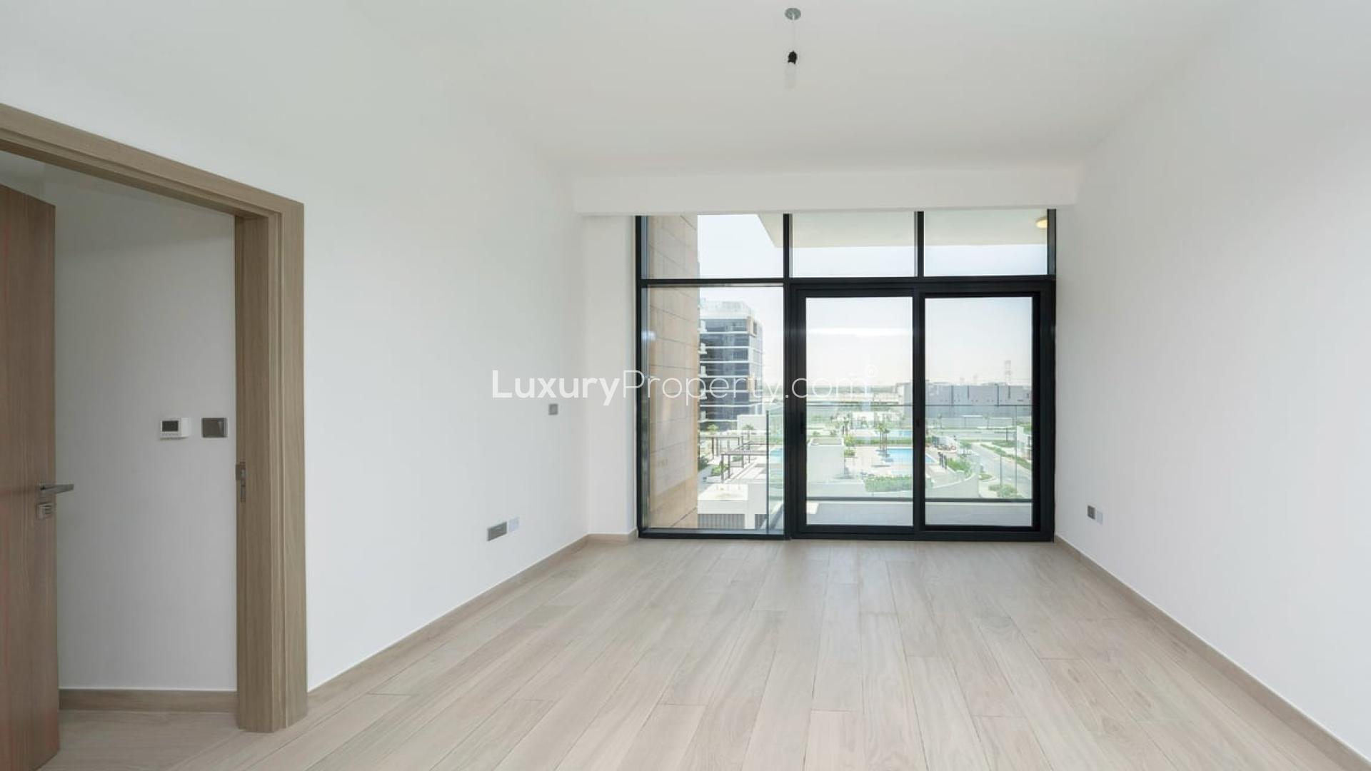 "Bright living room in 2-bedroom apartment, Azizi Riviera, Meydan Dubai with balcony view.",Modern bedroom with large windows in Azizi Riviera apartment, Meydan Dubai