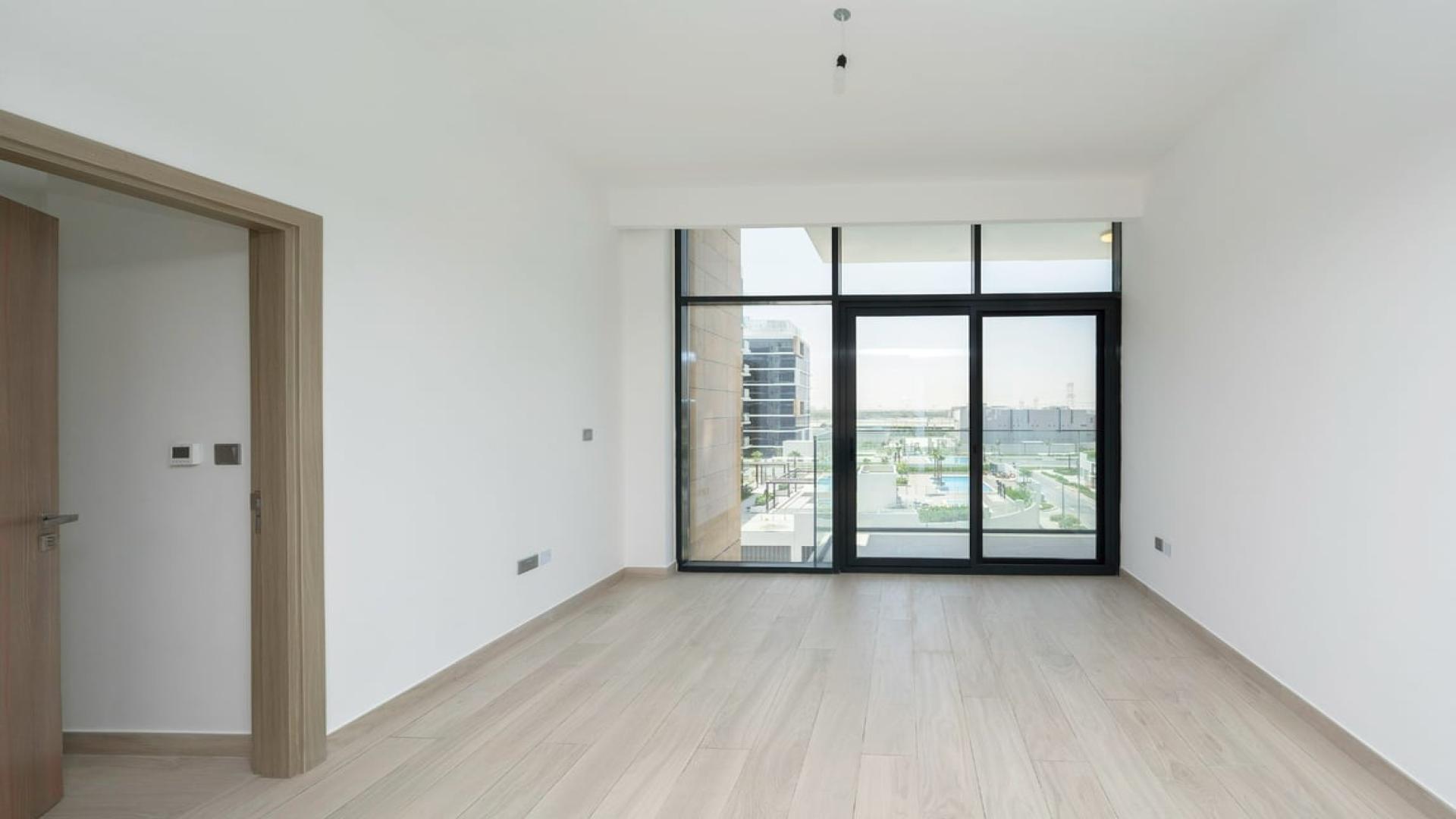 "Bright living room in 2-bedroom apartment, Azizi Riviera, Meydan Dubai with balcony view.",Modern bedroom with large windows in Azizi Riviera apartment, Meydan Dubai