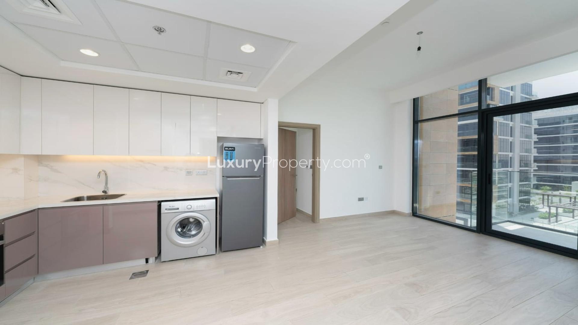 Modern kitchen in 2-bedroom apartment, Azizi Riviera, Meydan Dubai, with balcony view