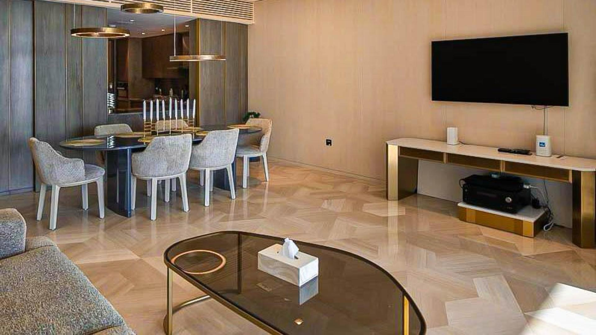 Luxury furnished living room in Palm Jumeirah apartment, featuring elegant dining area