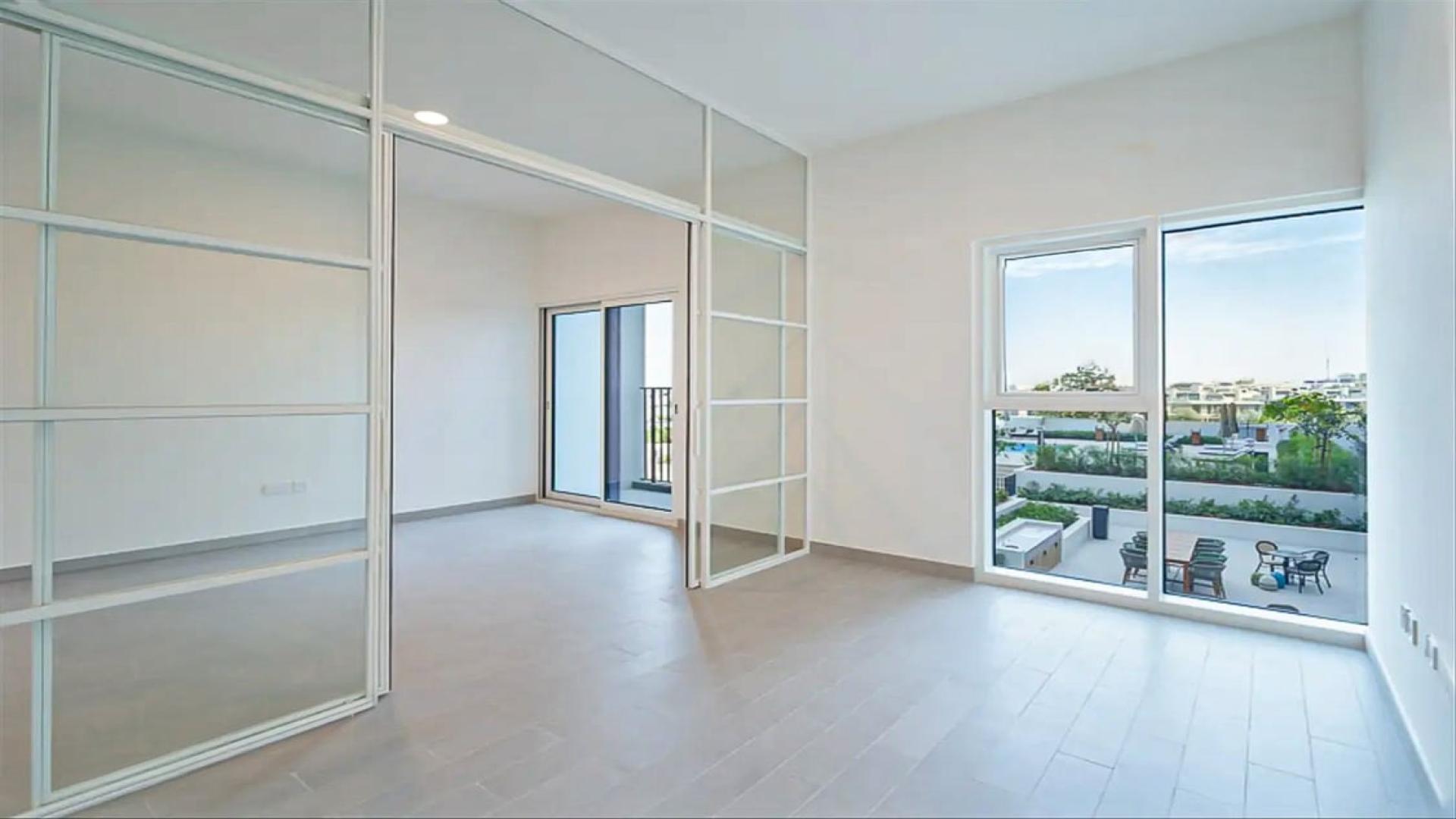 Modern kitchen in Dubai Hills Estate apartment, Golfville, with stylish cabinetry and tile flooring