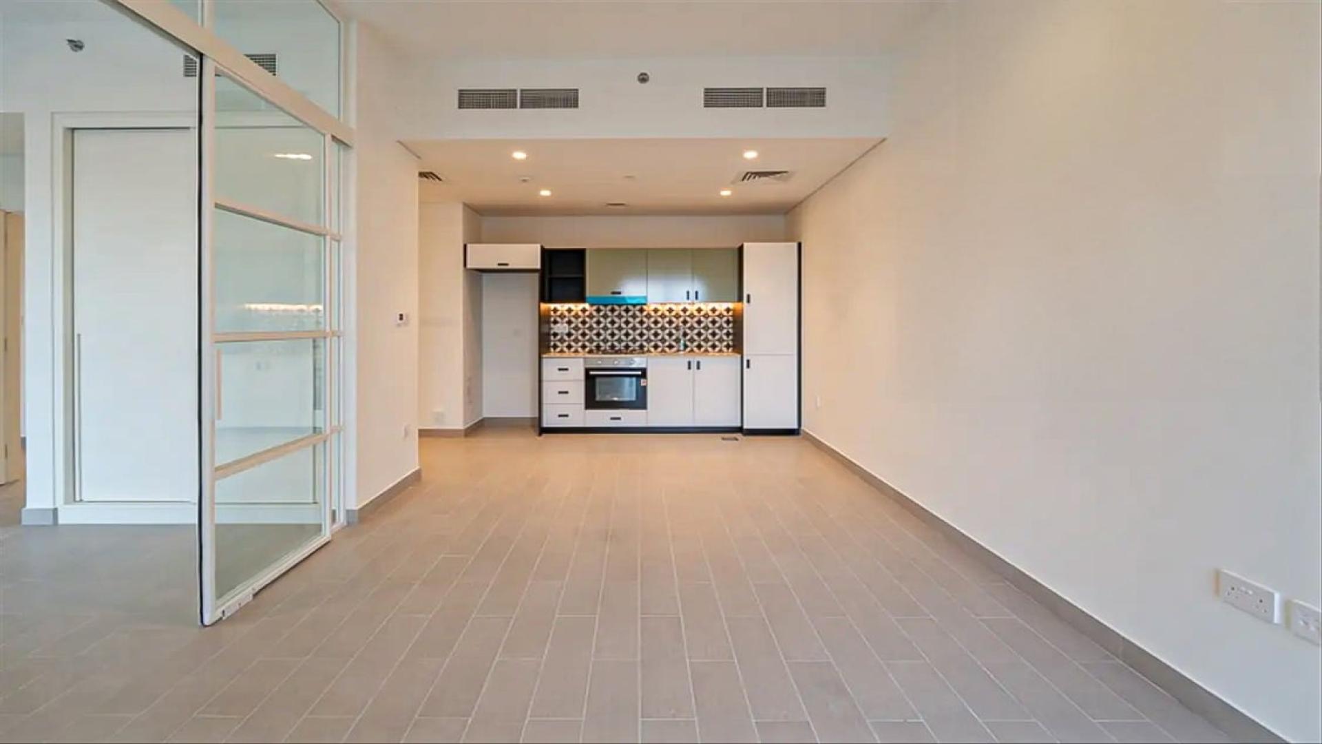 Empty corner apartment living area with balcony view in Dubai Hills Estate, Golfville