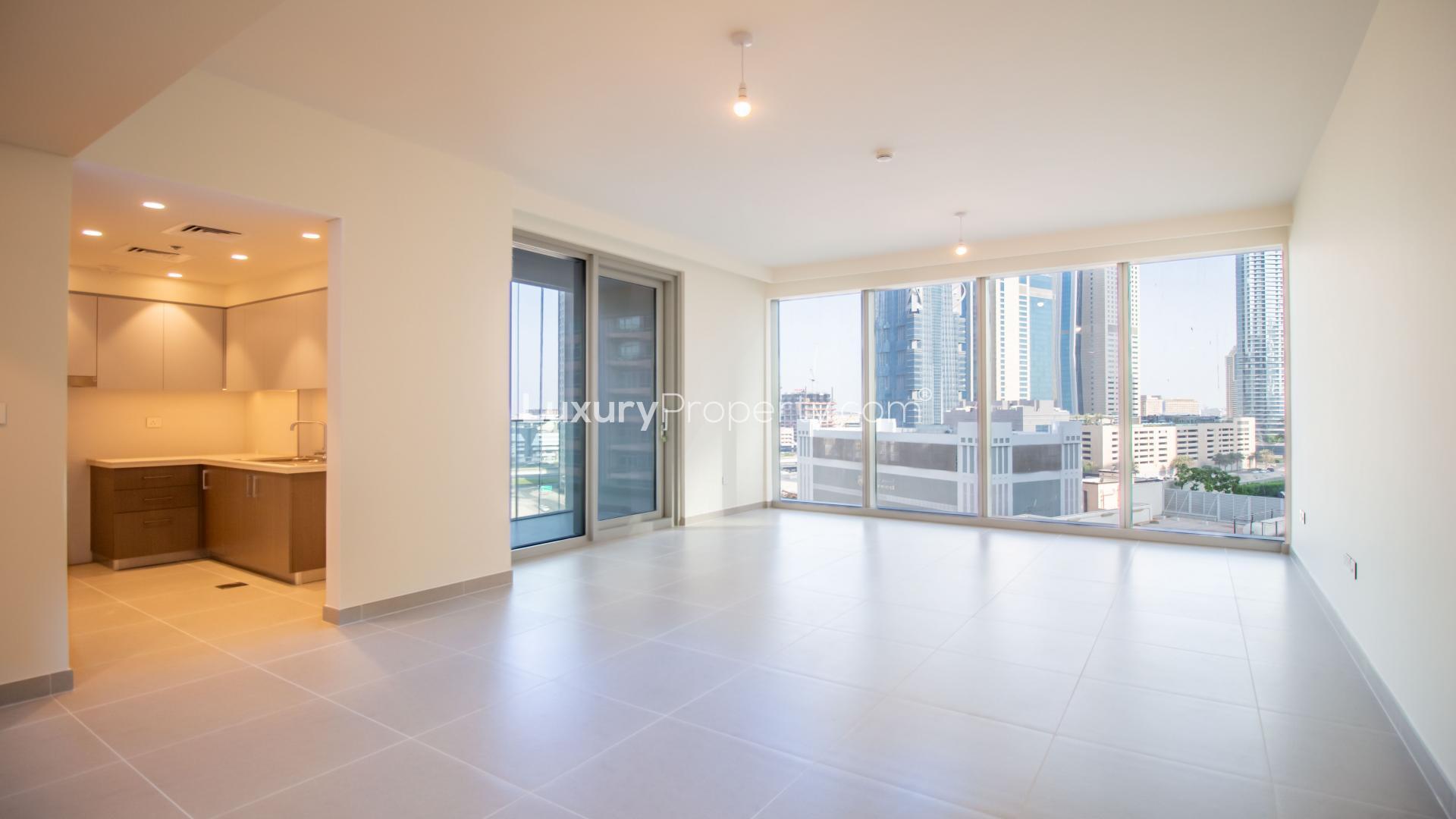 Empty living room in two-bedroom Forte apartment, Downtown Dubai, featuring modern tiled flooring