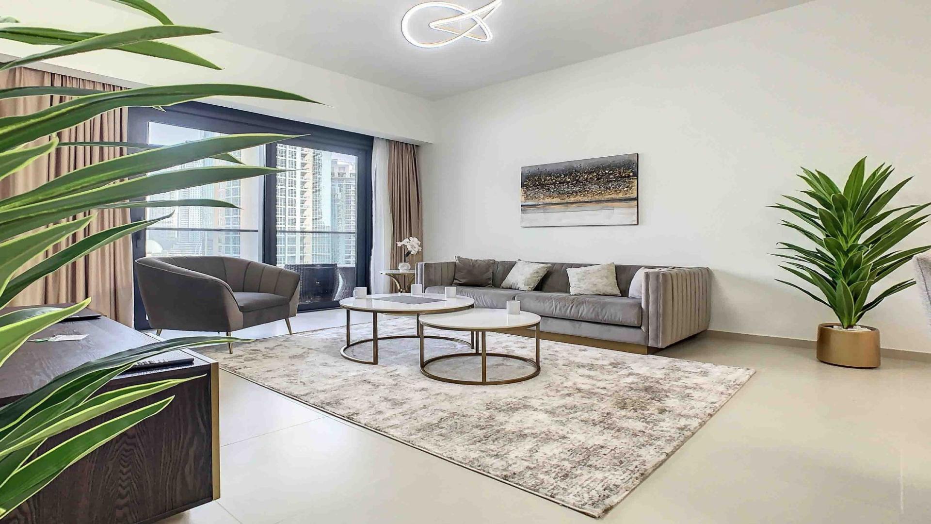 Furnished living room in 2-bedroom apartment, Act Towers, Downtown Dubai, modern decor and open layout