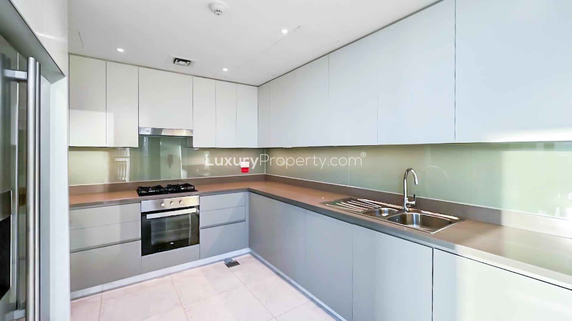 Modern kitchen in 2-bedroom apartment, BLVD Heights, Downtown Dubai, featuring sleek cabinetry and appliances